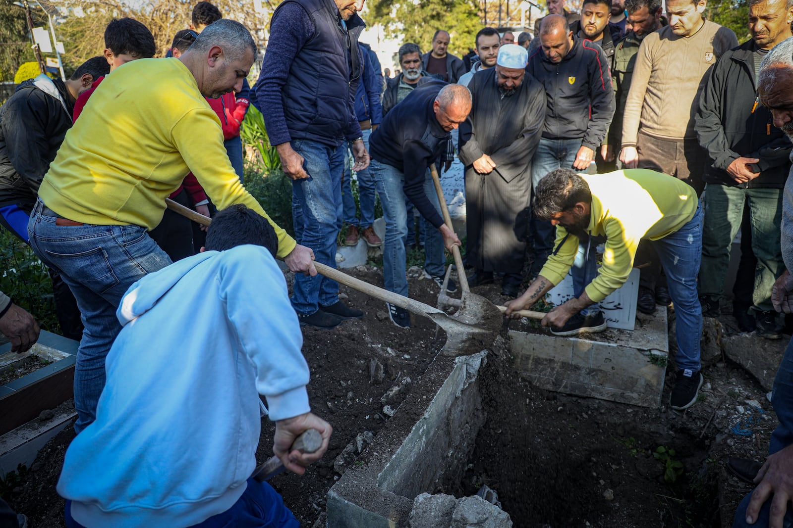 The coffin carrying the body of Nawaf Khalil Baytar, who was killed during the recent wave of violence between Syrian security forces and gunmen loyal to former President Bashar Assad, is is buried in Jableh, Syria's coastal region, Monday, March 10, 2025. (AP Photo/Omar Albam)