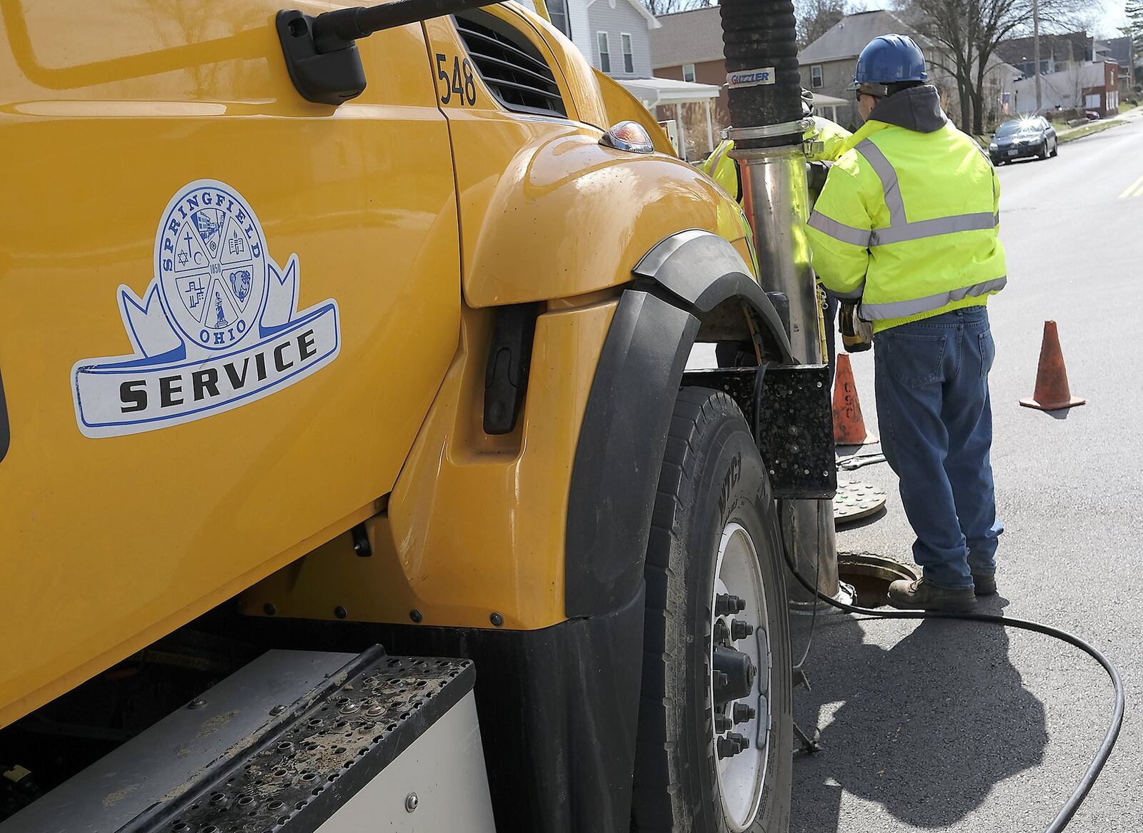 Springfield service workers clean out a sewer line Thursday. The city of Springfield is hosting financial forums ahead of its income tax issue on May 2. Bill Lackey/Staff