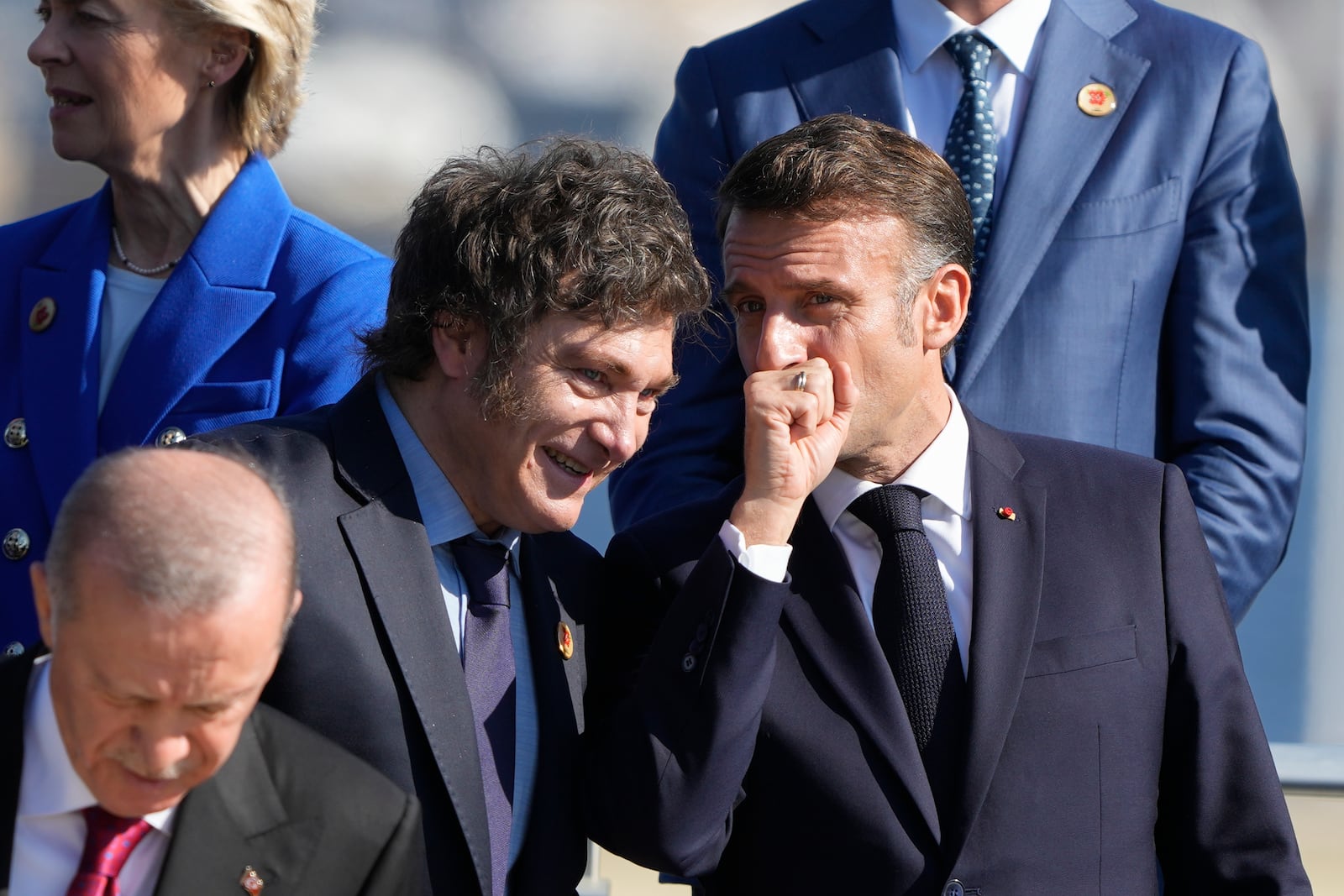 Argentina's President Javier Milei, left, and France's President Emmanuel Macron talk during a group photo at the G20 Summit in Rio de Janeiro, Monday, Nov. 18, 2024. (AP Photo/Eraldo Peres)