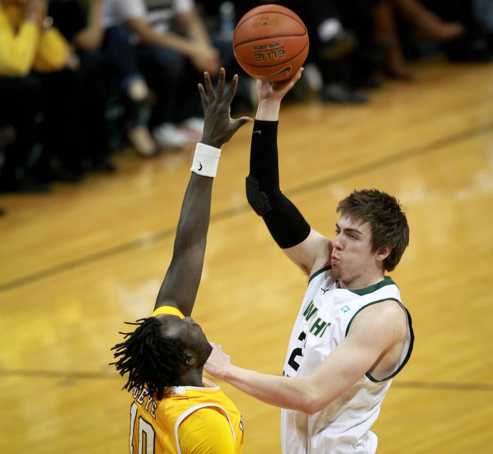 Wright State forward AJ Pacher shoots over Valaraiso’s Moussa Gueye at the Nutter Center Horizon League match-up in 2014. DDN FILE