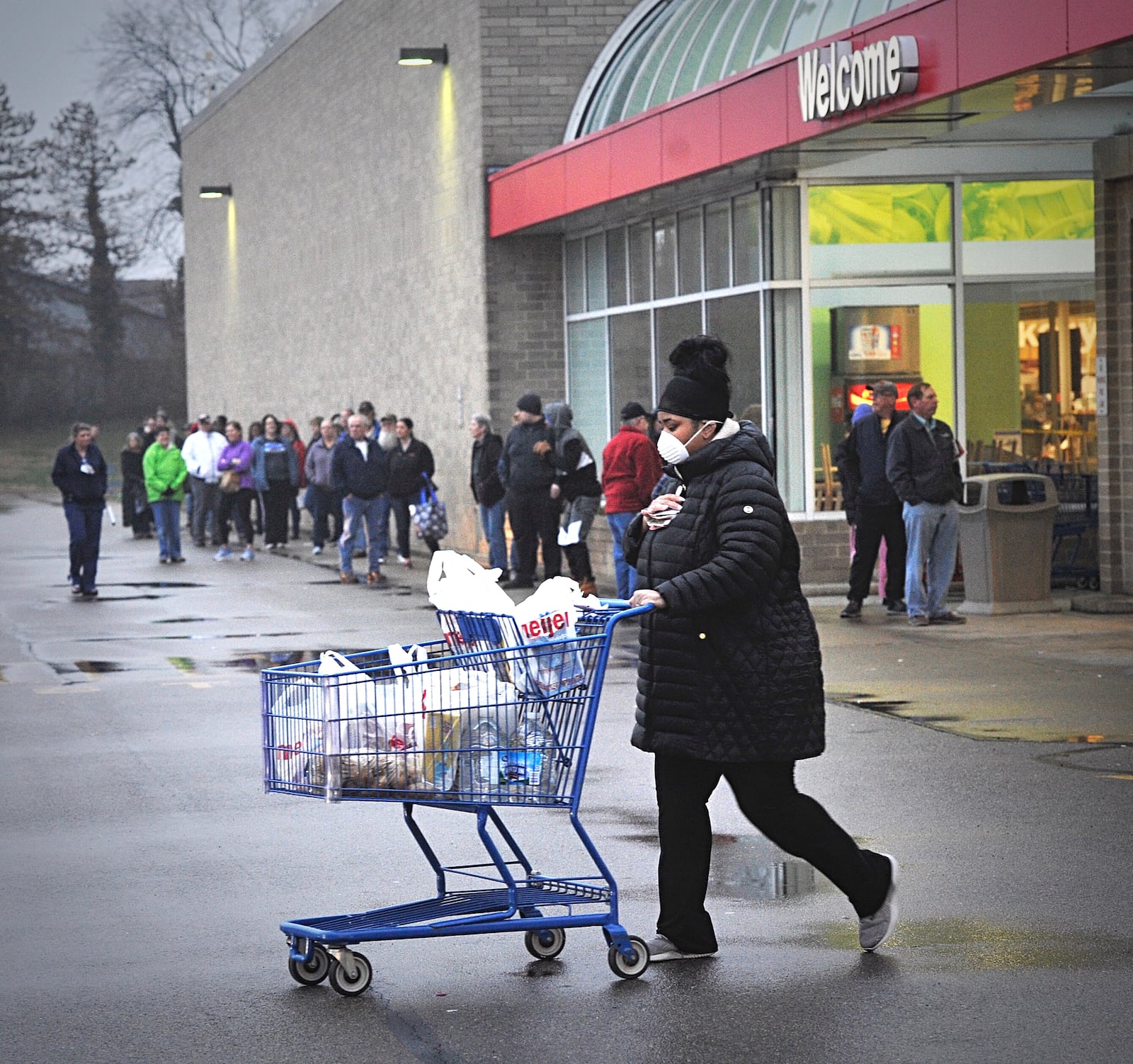 People wait outside the Springfield Meijer as essential workers have an opportunity to shop Monday morning. MARSHALL GORBY \ STAFF