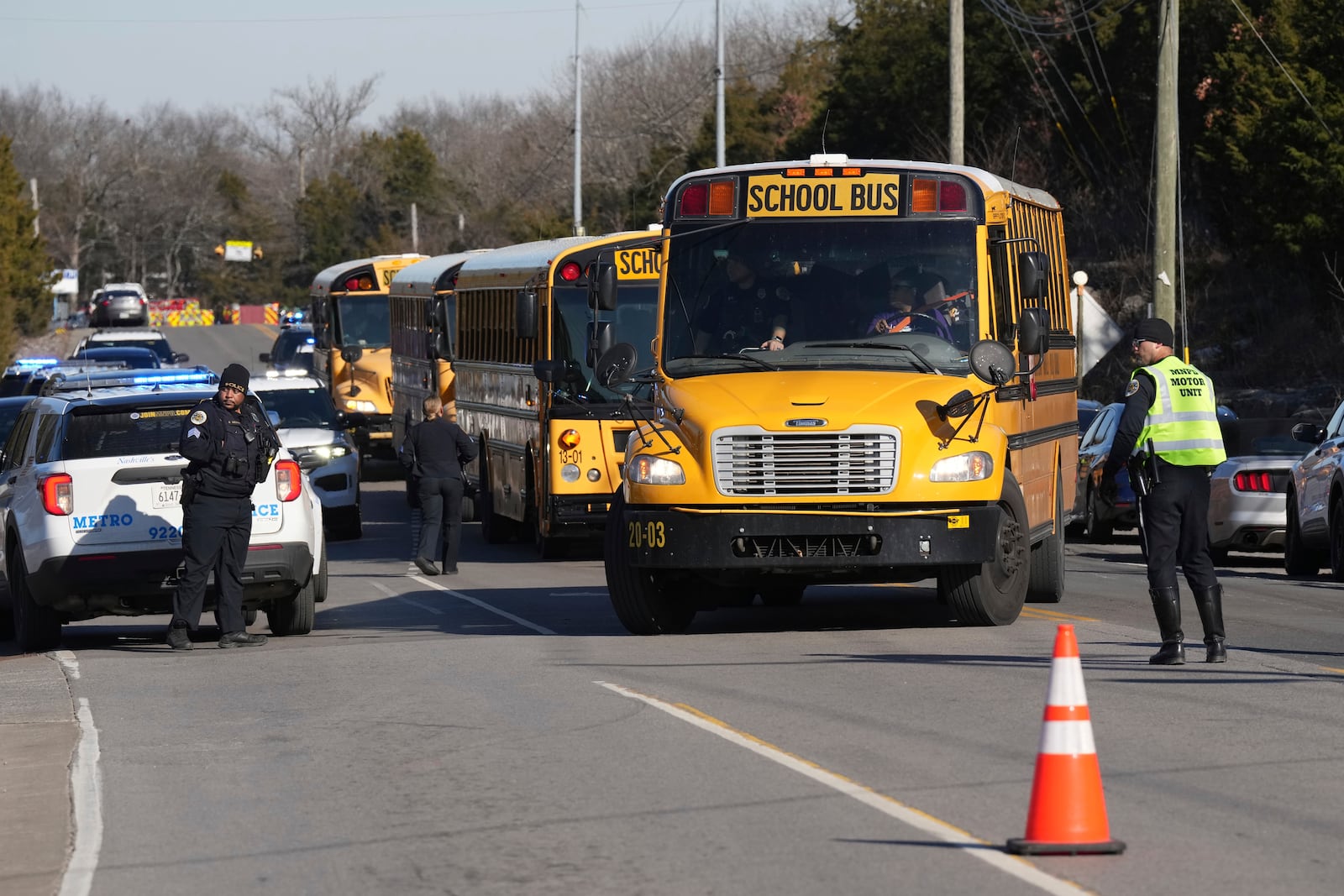 School buses arrive at a unification site following a shooting at the Antioch High School in Nashville, Tenn., Wednesday, Jan. 22, 2025. (AP Photo/George Walker IV)