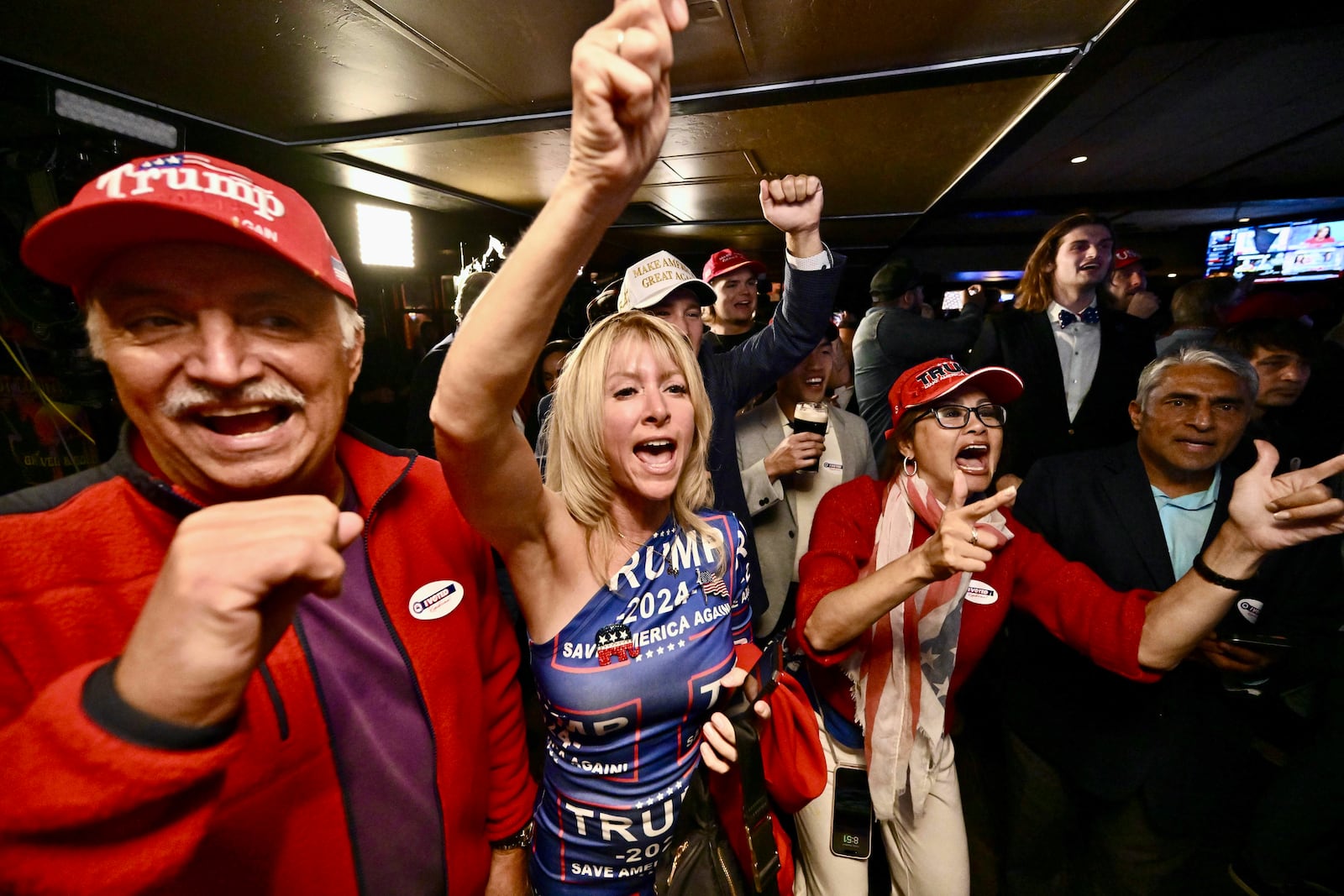 Ed Torres, left, and J. Carrie Torres join others as they celebrate the Republicans retaking the Senate during a GOP election night party at Muldoon's Irish Pub in Newport Beach. Calif., Tuesday, Nov. 4, 2024. (Jeff Gritchen/The Orange County Register via AP)