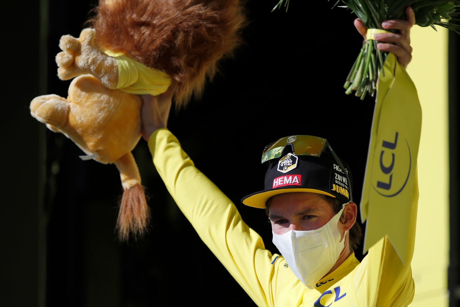 Slovenia's Primoz Roglic, wearing the overall leader's yellow jersey celebrates on the podium after the stage 12 of the Tour de France cycling race over 218 kilometers from Chauvigny to Sarran, Thursday, Sept. 10, 2020. (Stephane Mahe/Pool photo via AP)