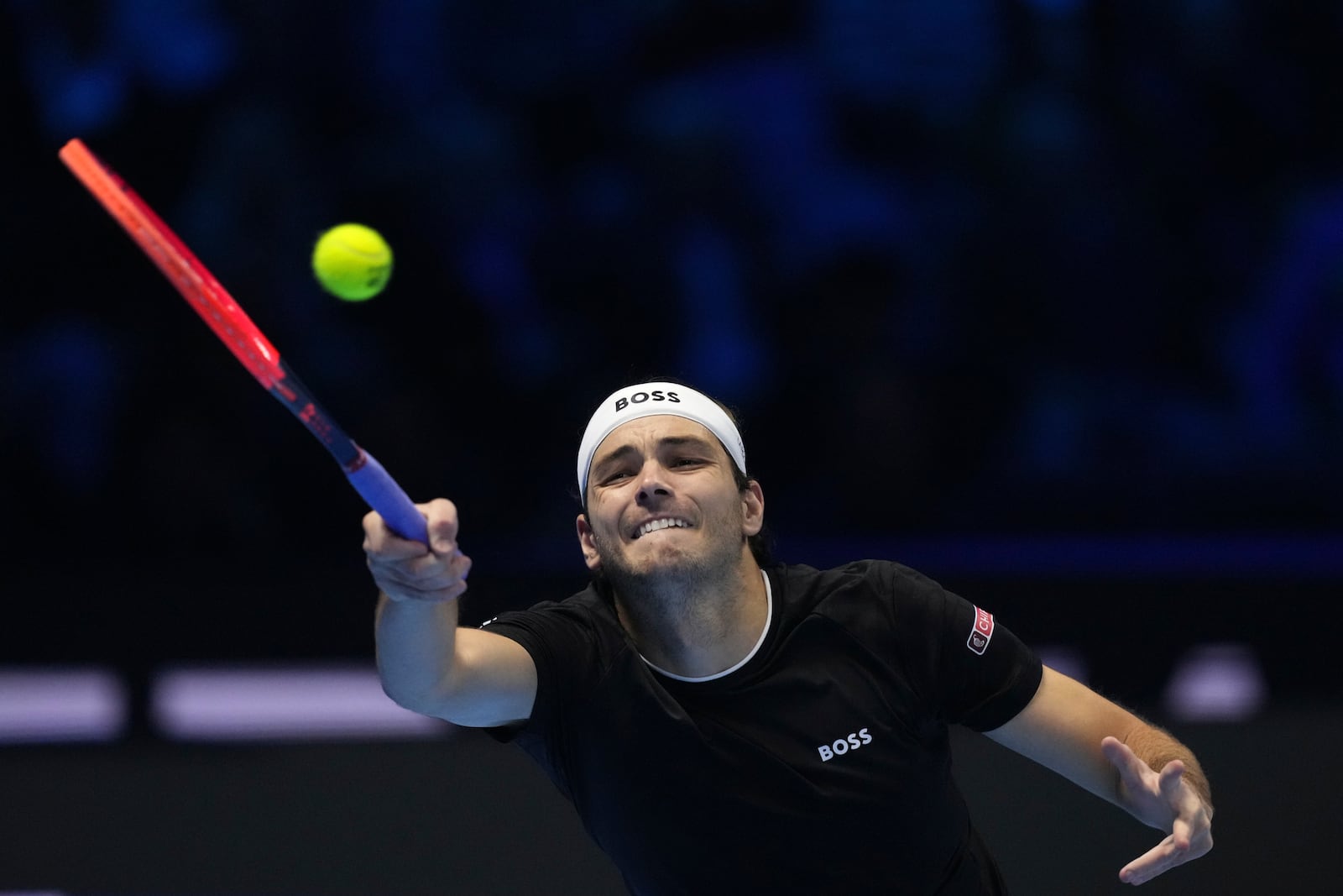 United States' Taylor Fritz returns the ball to Australia's Alex de Minaur during their singles tennis match of the ATP World Tour Finals at the Inalpi Arena, in Turin, Italy, Thursday, Nov. 14, 2024. (AP Photo/Antonio Calanni)