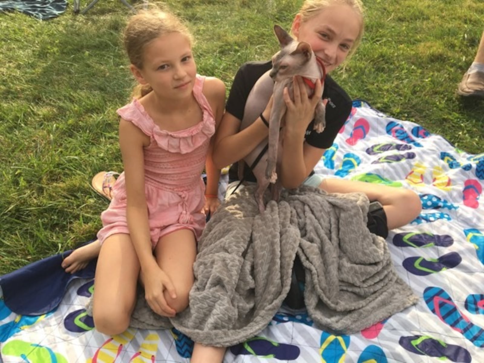 Aubrey and Ruby Clark hold “Gray” the only cat in attendance. Pam Cottrel/STAFF