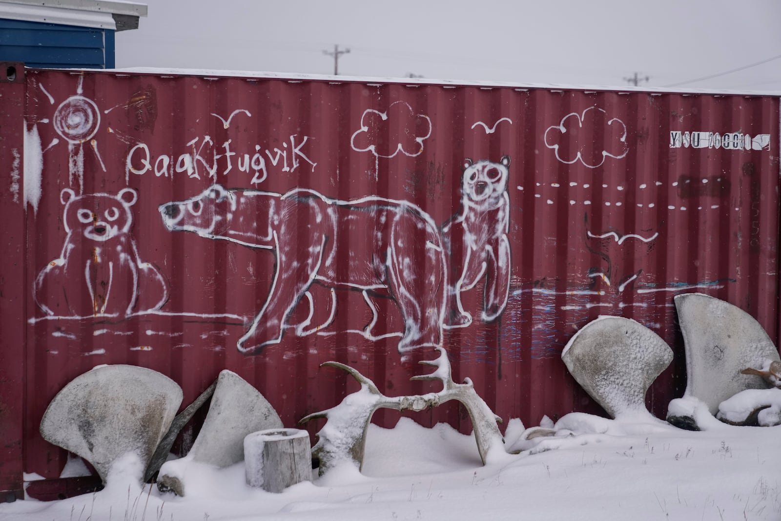 Polar bears and the Inupiaq word for "Kaktovik" are painted on a shipping container in the village of Kaktovik, Alaska, Wednesday, Oct. 16, 2024. (AP Photo/Lindsey Wasson)