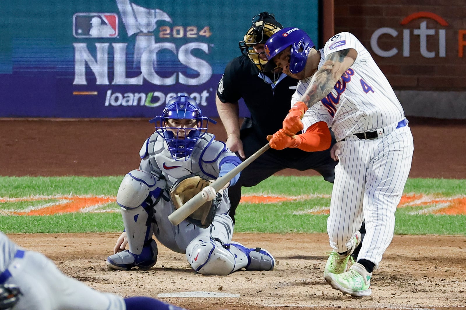 New York Mets' Francisco Alvarez hits a RBI-single against the Los Angeles Dodgers during the third inning in Game 5 of a baseball NL Championship Series, Friday, Oct. 18, 2024, in New York. (AP Photo/Adam Hunger)