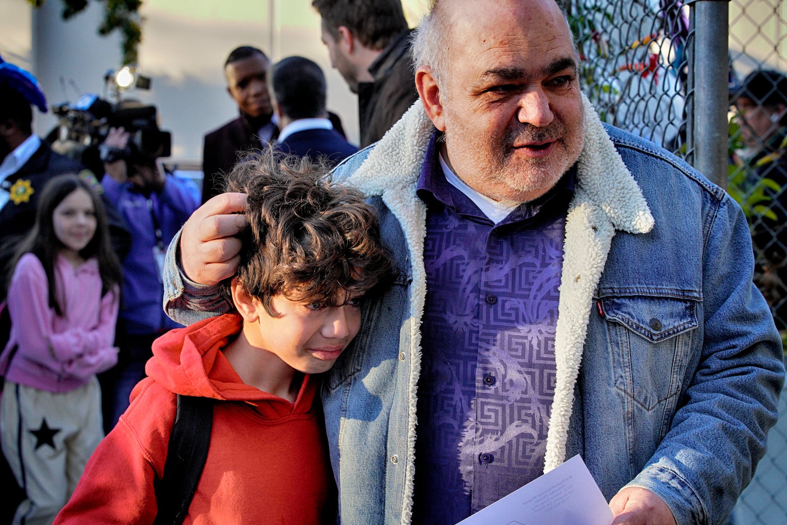 Palisades Charter Elementary School 3rd grade student Jaden Koshki cries in his father's arm Joseph Koshki upon arriving at his new school, the Brentwood Elementary Science Magnet school in the Brentwood section of Los Angeles on Wednesday, Jan. 15, 2025. (AP Photo/Richard Vogel)