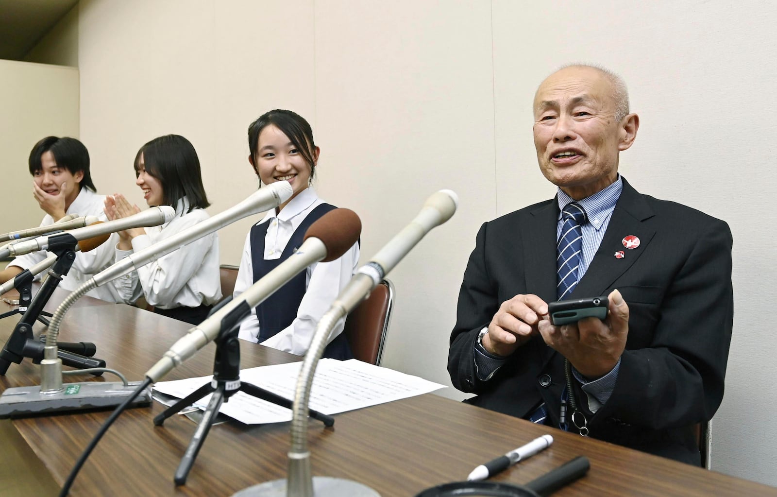 Toshiyuki Mimaki, right, president of Nihon Hidankyo, or the Japan Confederation of A- and H-Bomb Sufferers Organizations, speaks to media members in Hiroshima, Japan, Friday, Oct. 11, 2024, as he reacts to Ninon Hidankyo's winning the Nobel Peace Prize. (Moe Sasaki/Kyodo News via AP)