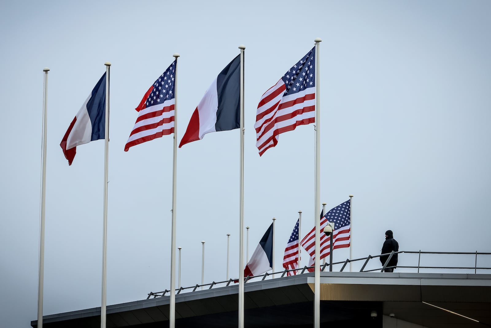 French and American flags flap in the wind prior to the arrival of United States Vice-President JD Vance at Paris Orly Airport, ahead of an Artificial Intelligence Action Summit taking place in Paris, Monday, Feb. 10, 2025. (AP Photo/Thomas Padilla)