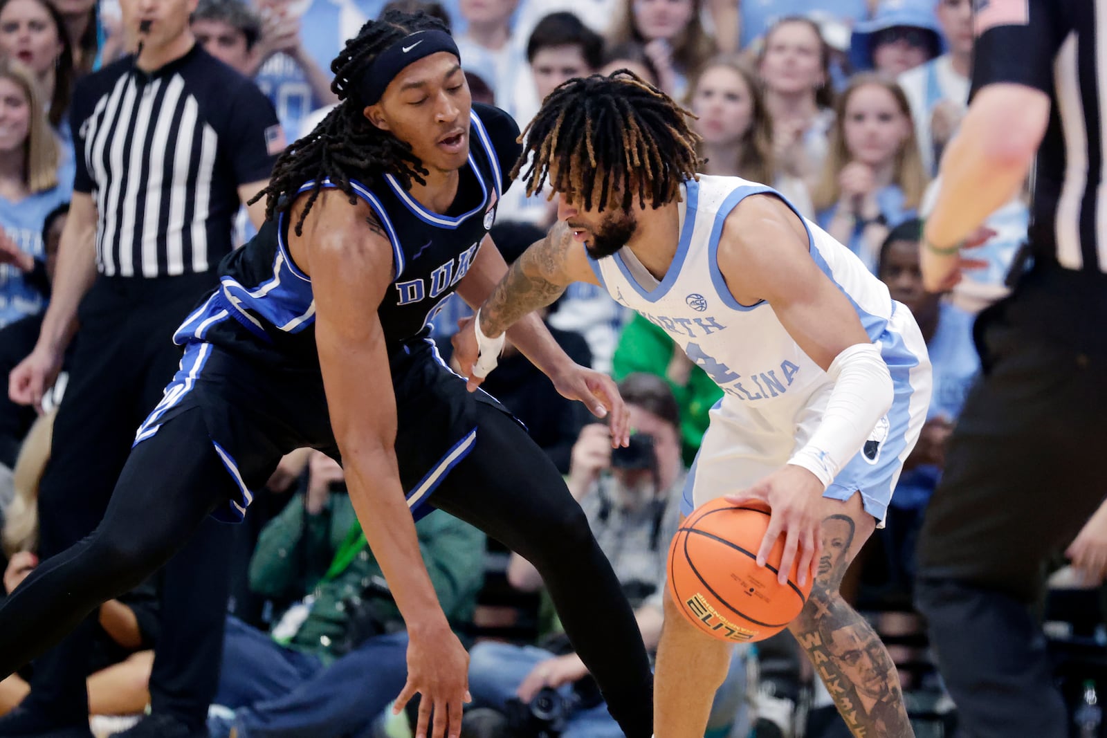 Duke forward Maliq Brown, left, defends North Carolina guard RJ Davis, right, during the second half of an NCAA college basketball game Saturday, March 8, 2025, in Chapel Hill, N.C. (AP Photo/Chris Seward)