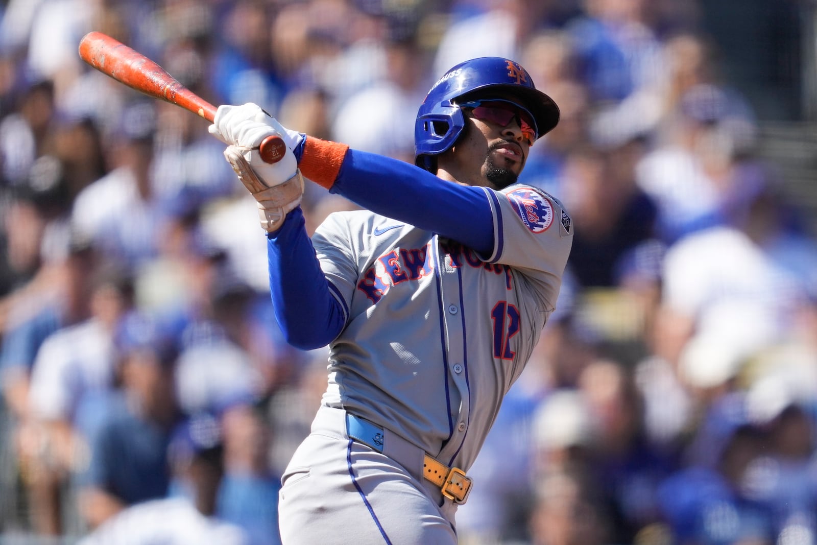 New York Mets' Francisco Lindor follows through as he hits a solo home run against the Los Angeles Dodgers during the first inning in Game 2 of a baseball NL Championship Series, Monday, Oct. 14, 2024, in Los Angeles. (AP Photo/Ashley Landis)