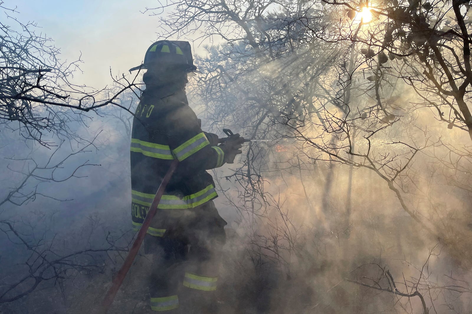 Firefighters respond to a brush fire in Suffolk County in New York's Long Island on Saturday, March 8, 2025. (Steve Pfost/Newsday via AP)