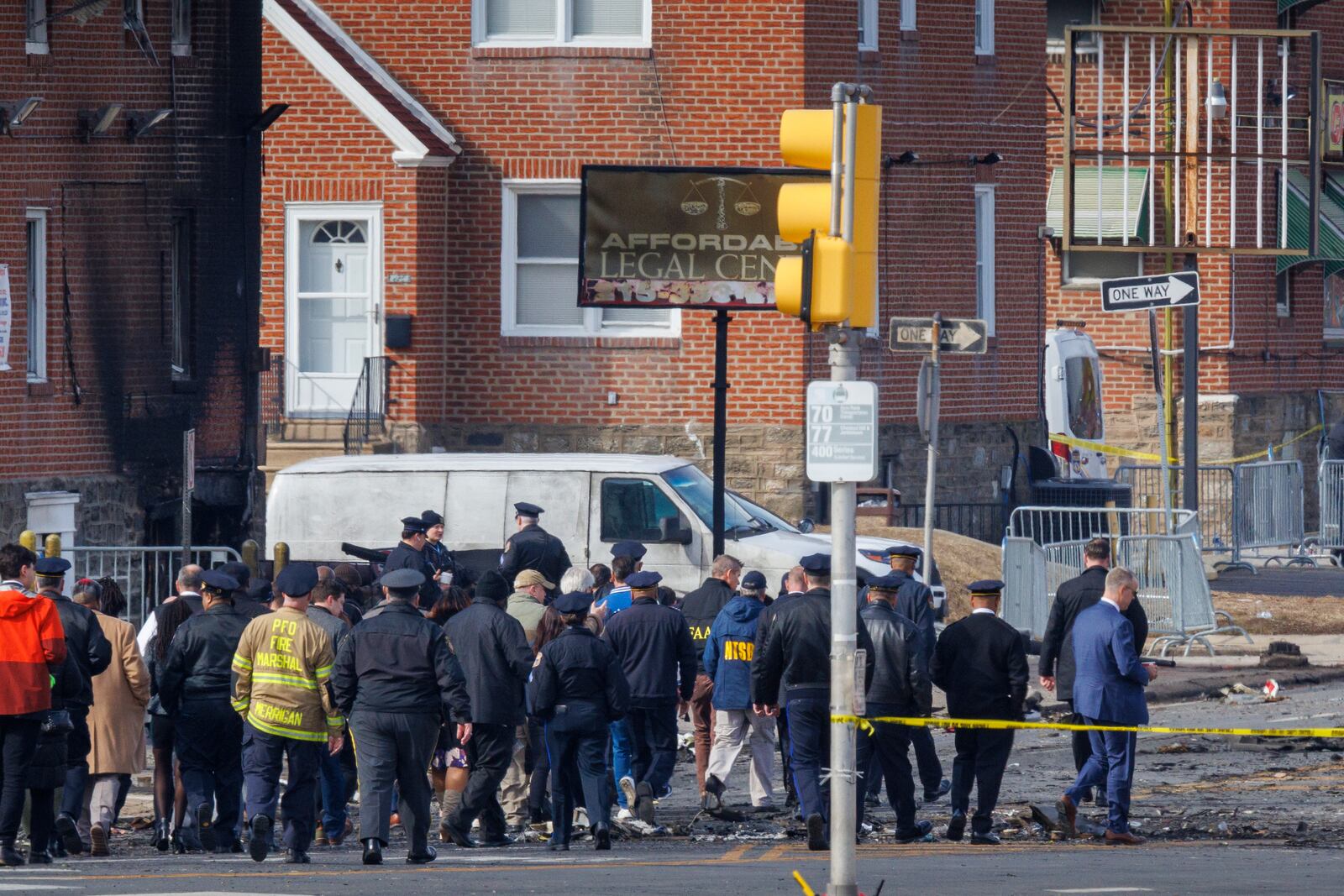 First responders, Philadelphia Mayor Cherelle Parker, United States Secretary of Transportation Sean Patrick Duffy and Pennsylvania Governor Josh Shapiro survey the scene of a medical jet crash Monday morning Feb. 3, 2025 in Philadelphia. (Alejandro A. Alvarez/The Philadelphia Inquirer via AP)