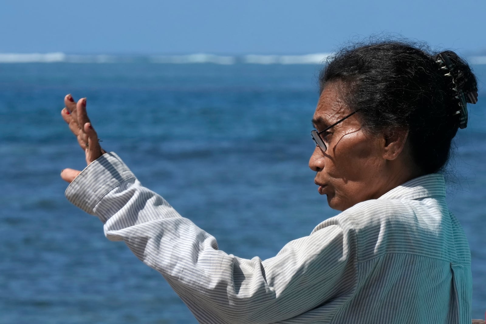 Netina Malae talks about how a New Zealand navy ship ran aground and sank on Oct. 6, near her Sima PJ Beach Fale resort in the village of Tafitoala, Samoa, Monday, Oct. 21, 2024. (AP Photo/Rick Rycroft)