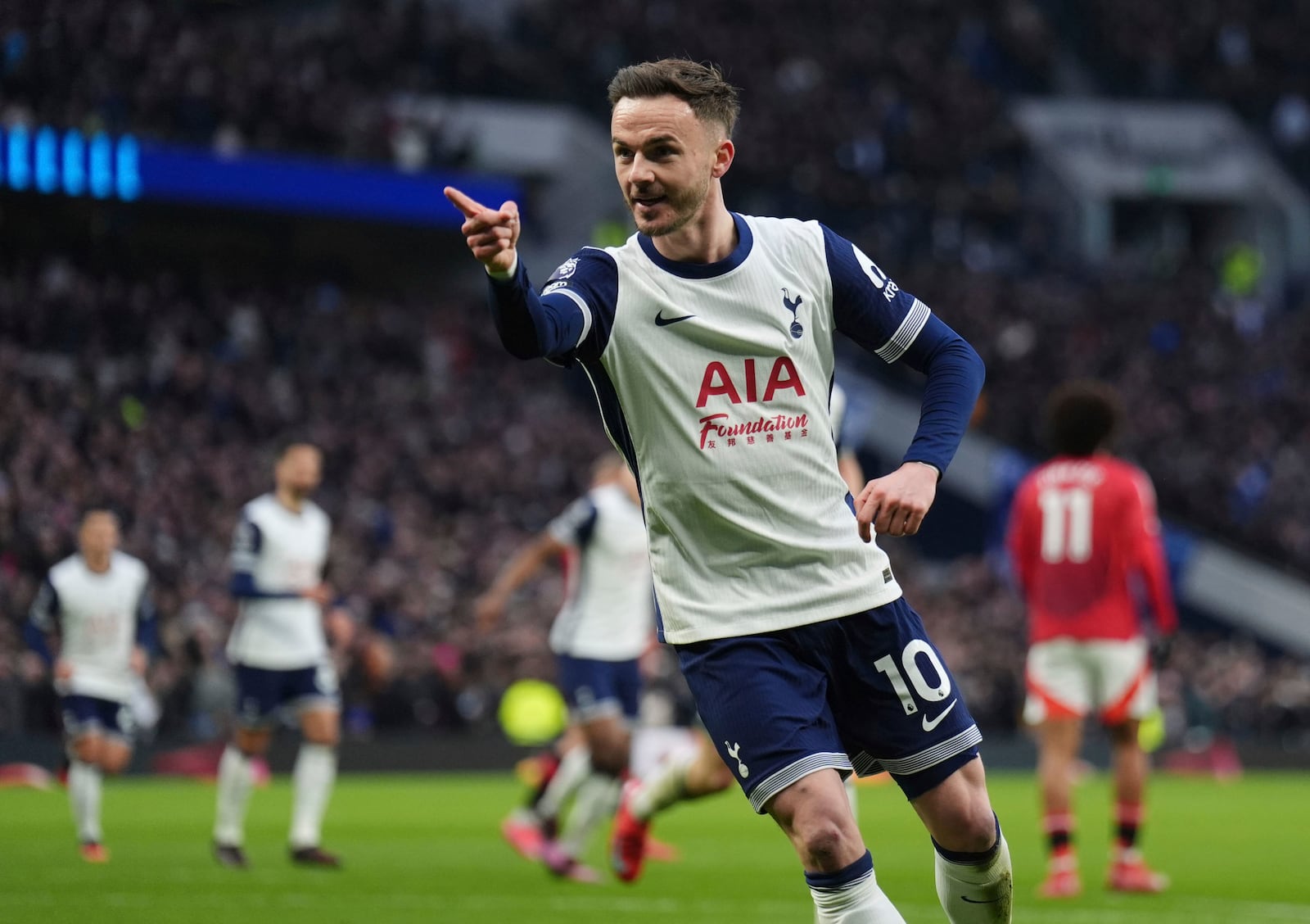 Tottenham's James Maddison celebrates after scoring the opening goal during the English Premier League soccer match between Tottenham Hotspur and Manchester United in London, Sunday, Feb. 16, 2025. (John Walton/PA via AP)