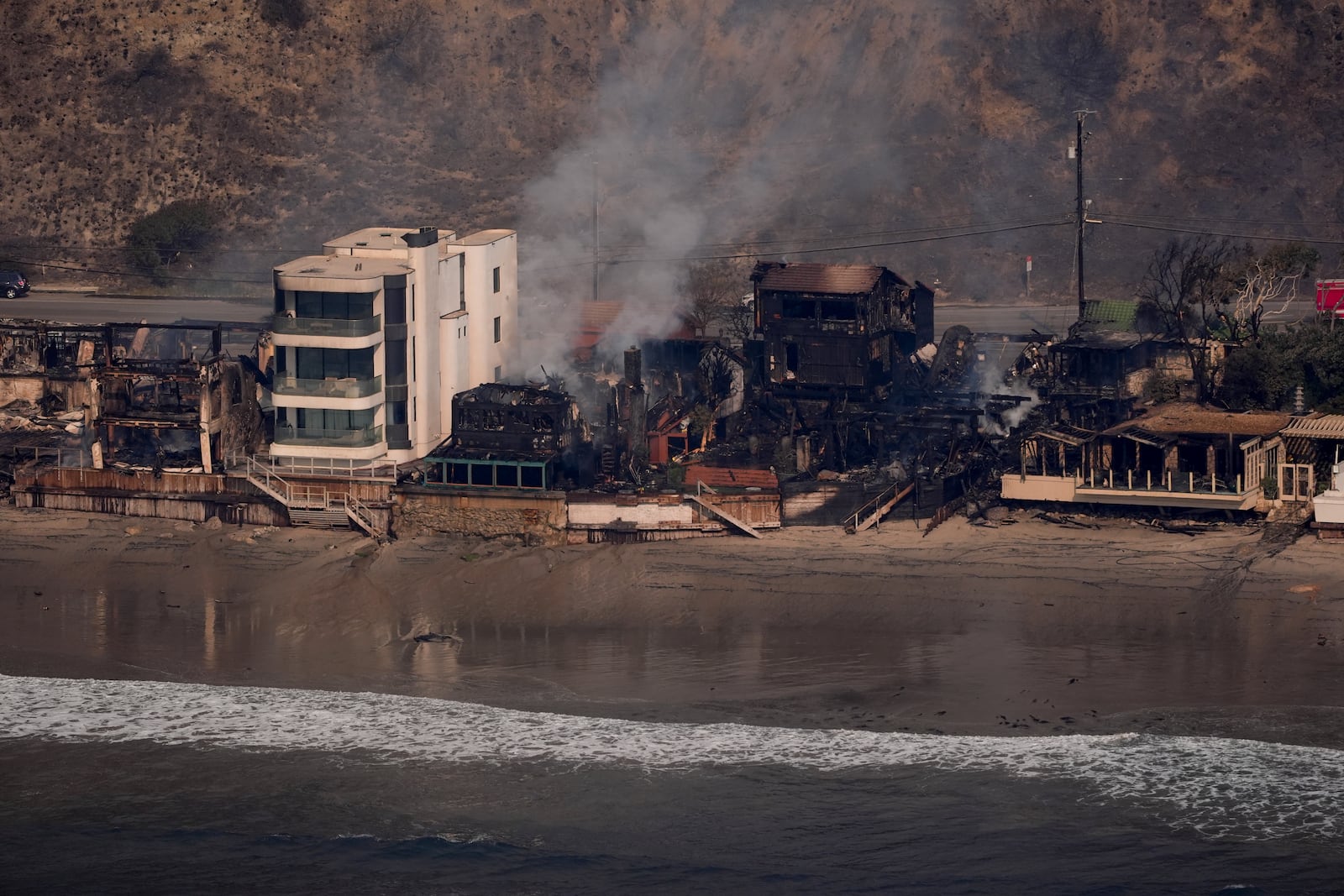 Beach front properties are left destroyed by the Palisades Fire, in this aerial view, Thursday, Jan. 9, 2025 in Malibu, Calif. (AP Photo/Mark J. Terrill)