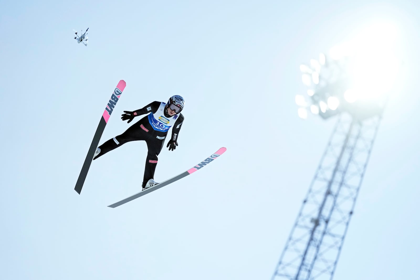 =Marius Lindvik, of Norway, soars through the air during his first round jump of the ski jumping men's team large hill competition at the Nordic World Ski Championships in Trondheim, Norway, Thursday, March 6, 2025. (AP Photo/Matthias Schrader)