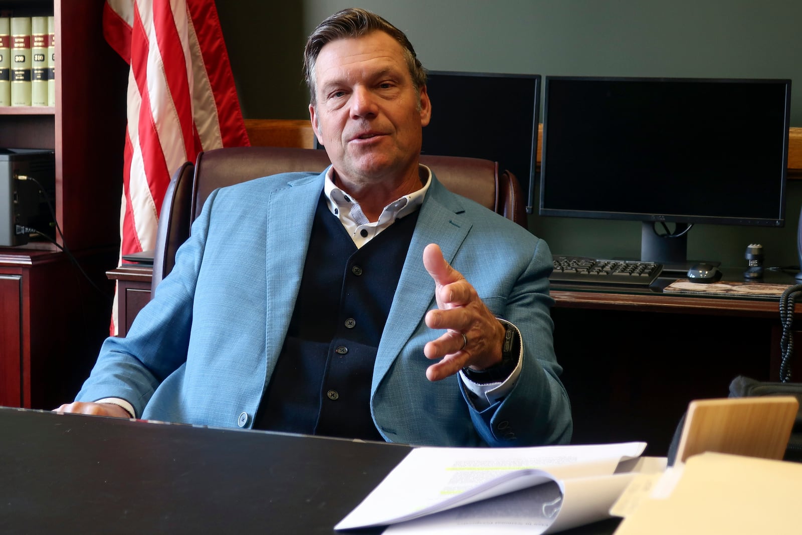 Kansas Attorney General Kris Kobach, who's informally advising President-elect Donald Trump's transition team, discusses immigration issues during an interview with The Associated Press, Wednesday, Dec. 18, 2024, in his office in Topeka, Kan. (AP Photo/John Hanna)