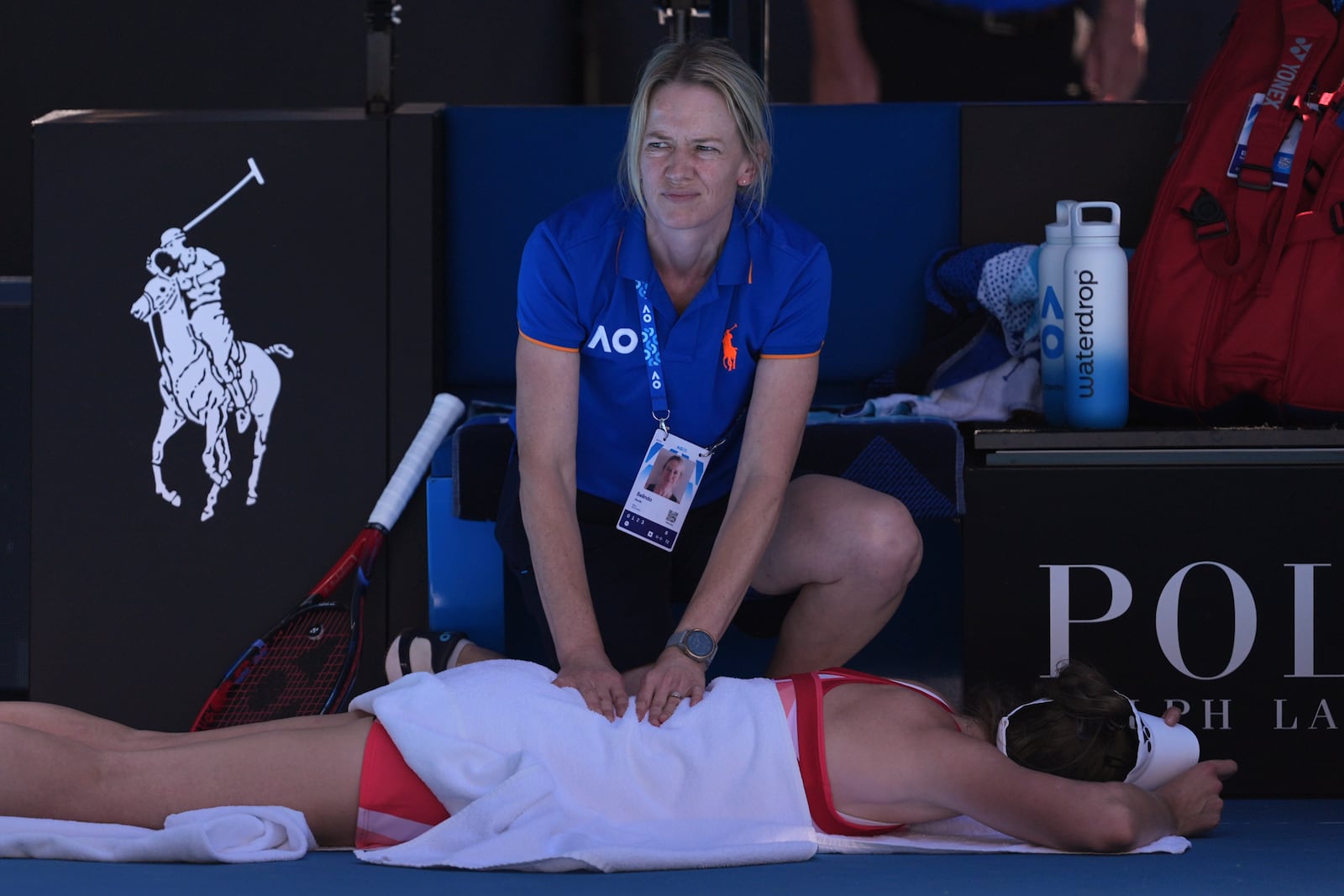 Elena Rybakina of Kazakhstan receives treatment from a trainer during her third round match against Dayana Yastremska of Ukraine at the Australian Open tennis championship in Melbourne, Australia, Saturday, Jan. 18, 2025. (AP Photo/Ng Han Guan)