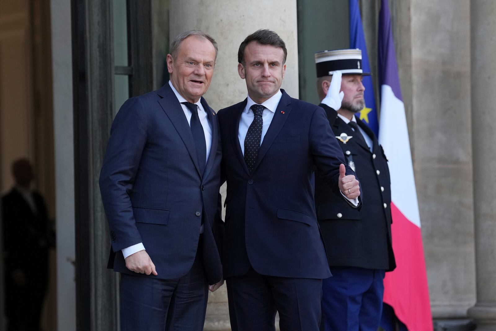 French President Emmanuel Macron, right, greets Poland's Prime Minister Donald Tusk as he arrives for an informal meeting of leaders from key European Union nations and the United Kingdom at the Elysee Palace in Paris, Monday, Feb. 17, 2025. (AP Photo/Aurelien Morissard)