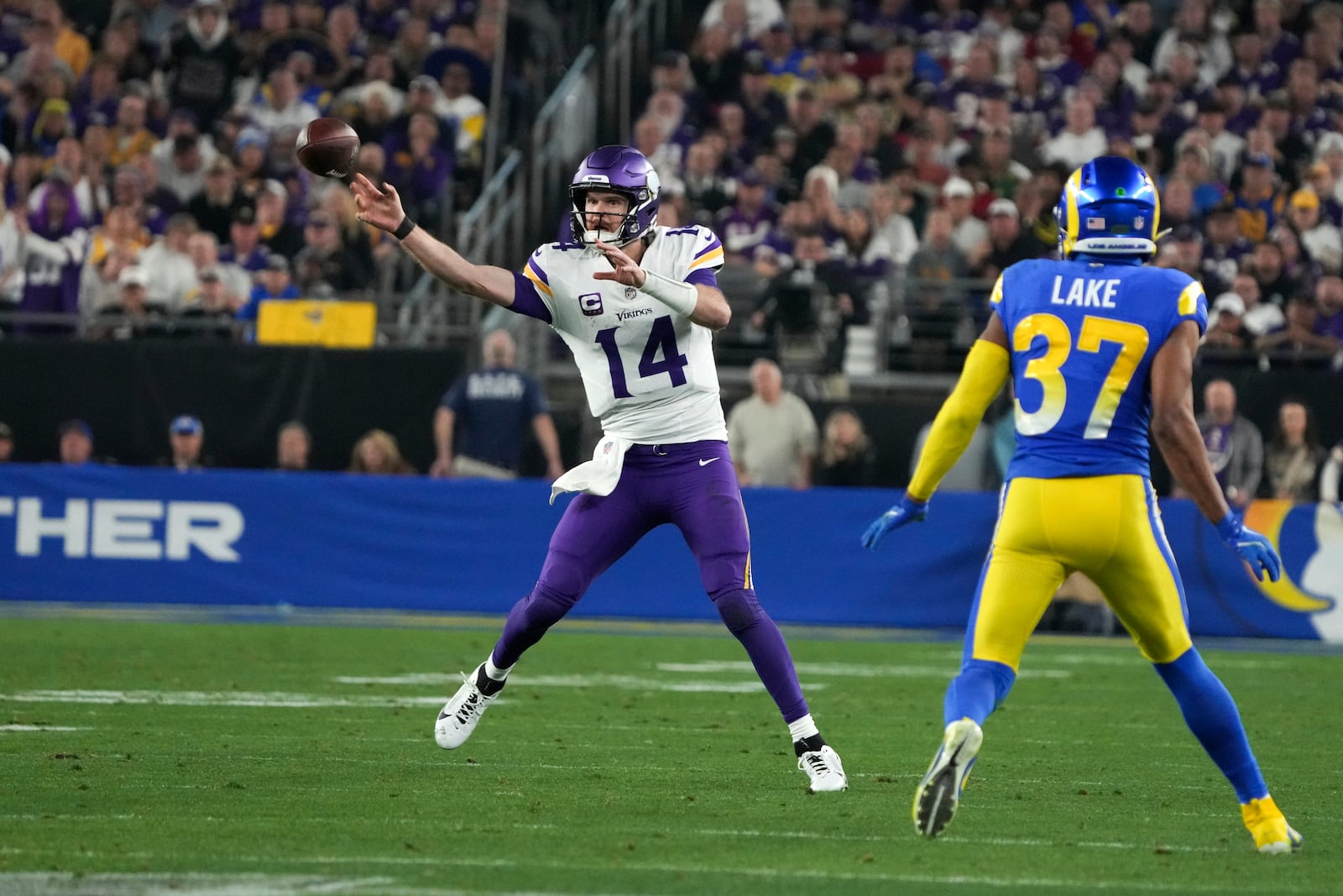 Minnesota Vikings quarterback Sam Darnold (14) throws as Los Angeles Rams safety Quentin Lake (37) defends during the second half of an NFL wild card playoff football game, Monday, Jan. 13, 2025, in Glendale, Ariz. (AP Photo/Rick Scuteri)