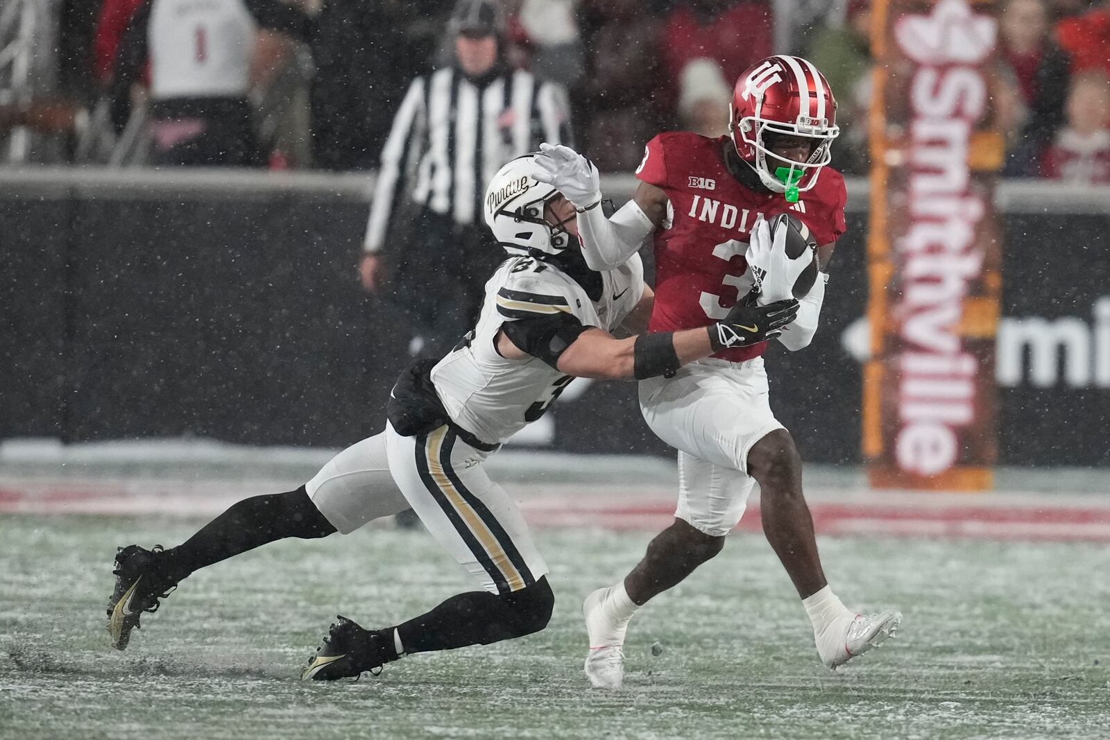 FILE - Indiana wide receiver Omar Cooper Jr. (3) is tackled by Purdue defensive back Dillon Thieneman (31) during the first half of an NCAA college football game, Saturday, Nov. 30, 2024, in Bloomington, Ind. (AP Photo/Darron Cummings, File)