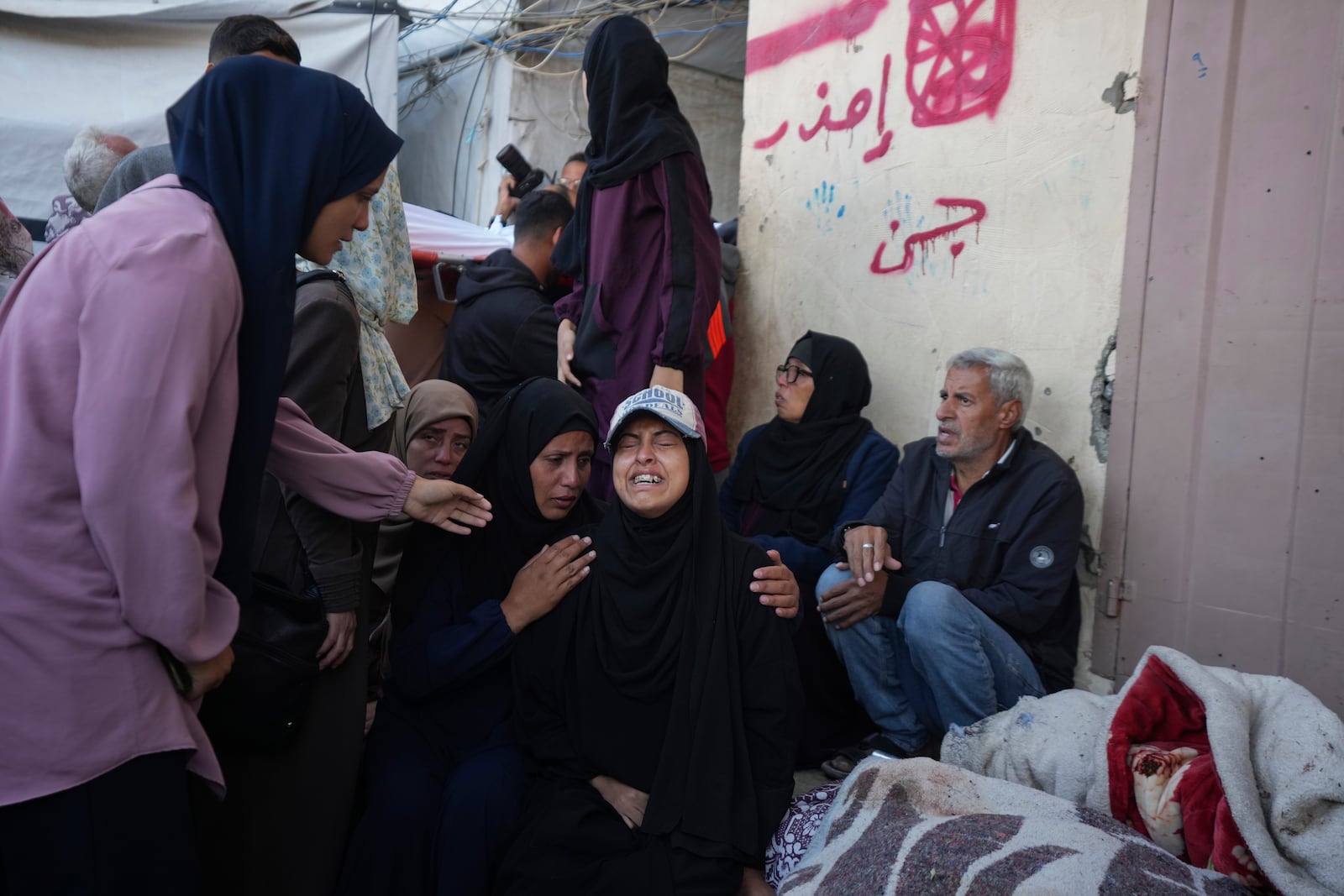 Palestinians mourn nine people killed in an Israeli strike in Bureij refugee camp, Gaza Strip, Friday, Nov. 15, 2024. (AP Photo/Abdel Kareem Hana)