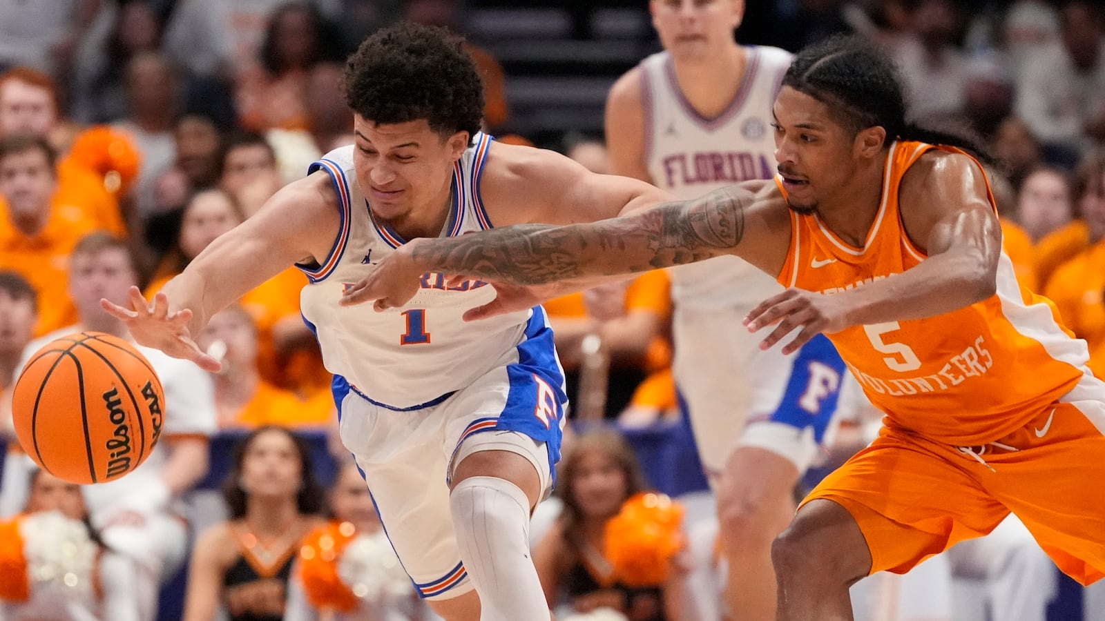 Florida guard Walter Clayton Jr. (1) and Tennessee guard Zakai Zeigler (5) chase a loose ball during the second half of an NCAA college basketball game in the final round of the Southeastern Conference tournament, Sunday, March 16, 2025, in Nashville, Tenn. (AP Photo/George Walker IV)