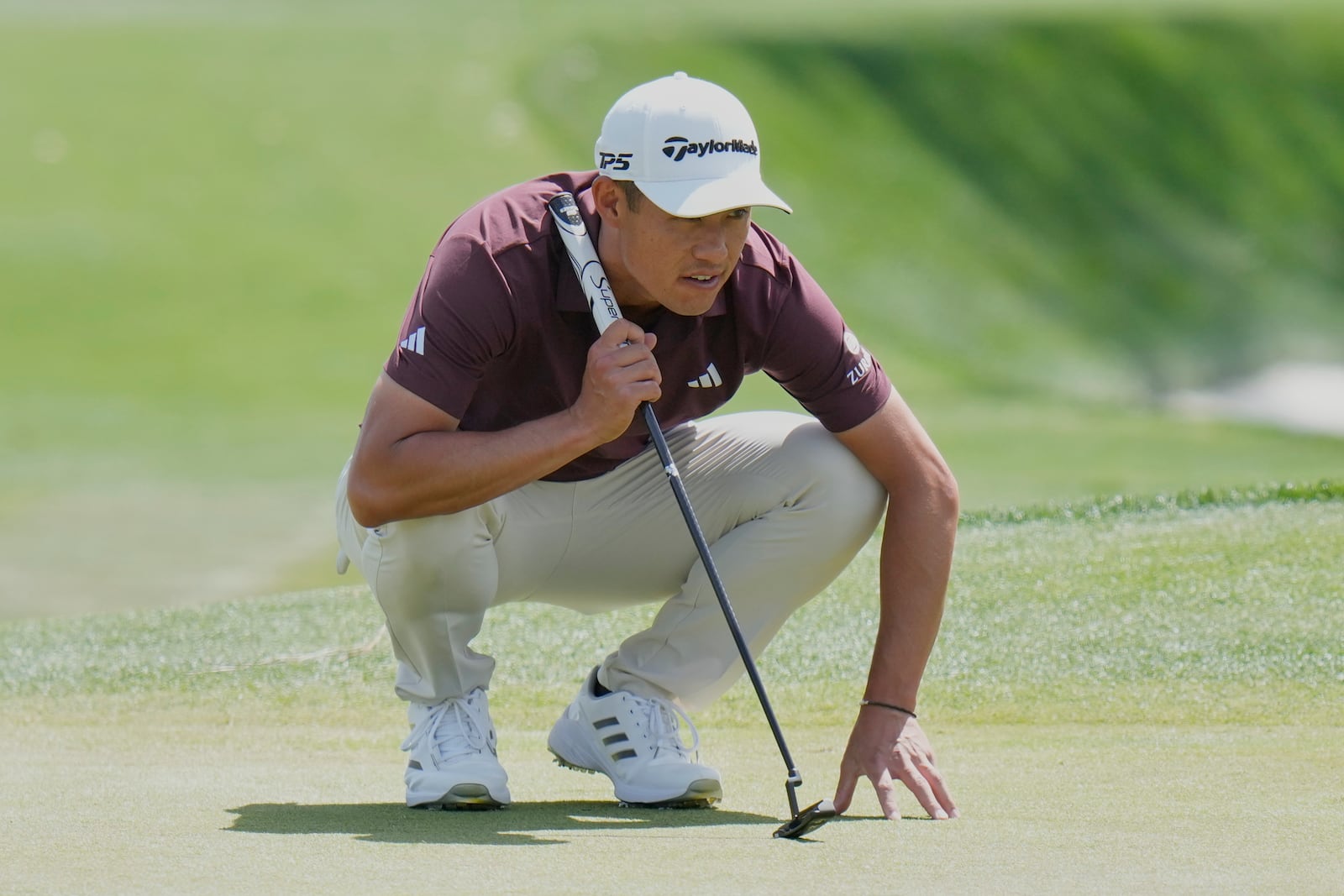 Collin Morikawa lines up a birdie putt on the ninth hole during the second round of The Players Championship golf tournament Friday, March 14, 2025, in Ponte Vedra Beach, Fla. (AP Photo/Chris O'Meara)