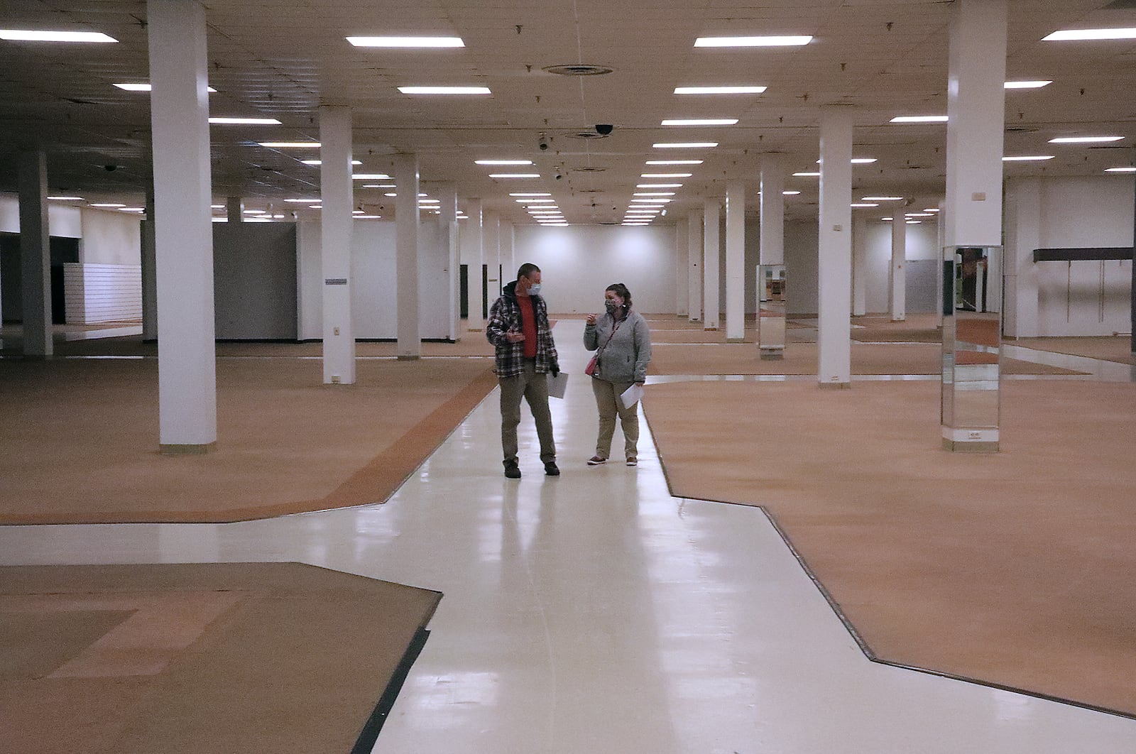 Members of the Clark County Combined Health District walk through the vacant JCPenney store at the Upper Valley Mall in December 2020. The health district now uses the JCPenney store as a COVID-19 vaccination site. BILL LACKEY/STAFF