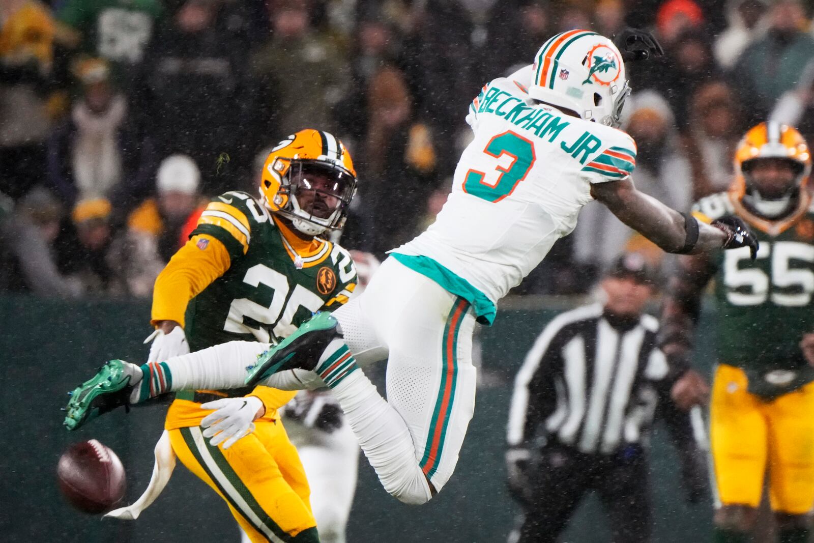 Green Bay Packers cornerback Keisean Nixon (25) breaks up a pass intended for Miami Dolphins wide receiver Odell Beckham Jr. (3) during the second half of an NFL football game Thursday, Nov. 28, 2024, in Green Bay, Wis. (AP Photo/Morry Gash)