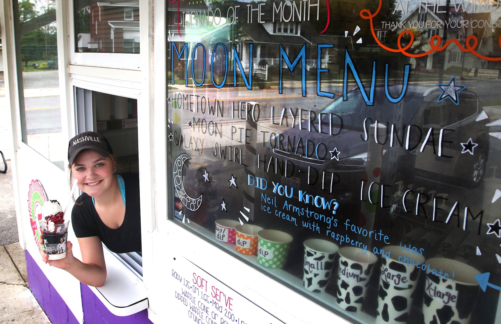 Haley Schattschneider serves up a "Home Town Hero Sundae" at Scoops in Wapakoneta. The dessert is on the Moon Menu Trail, a culinary tribute to the first moon landing in 1969. LISA POWELL / STAFF