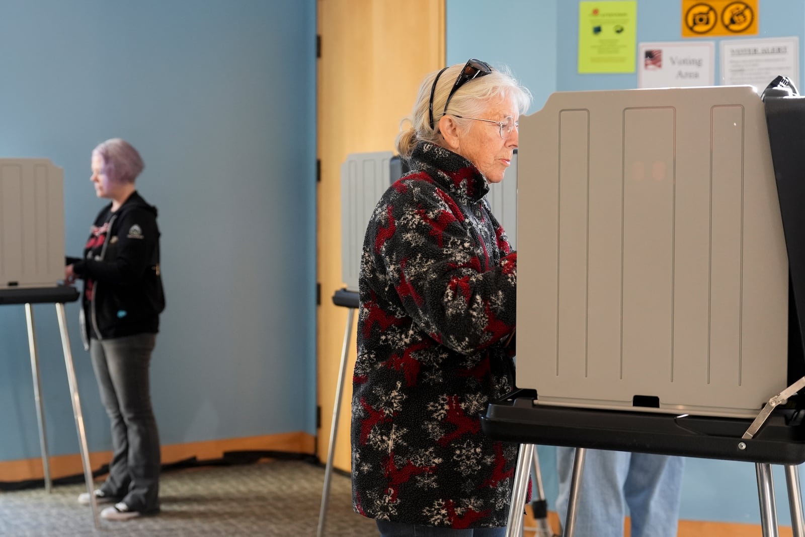 Voters mark their ballots during early in-person voting, Thursday, Oct. 17, 2024, in Asheville, N.C. (AP Photo/Stephanie Scarbrough)