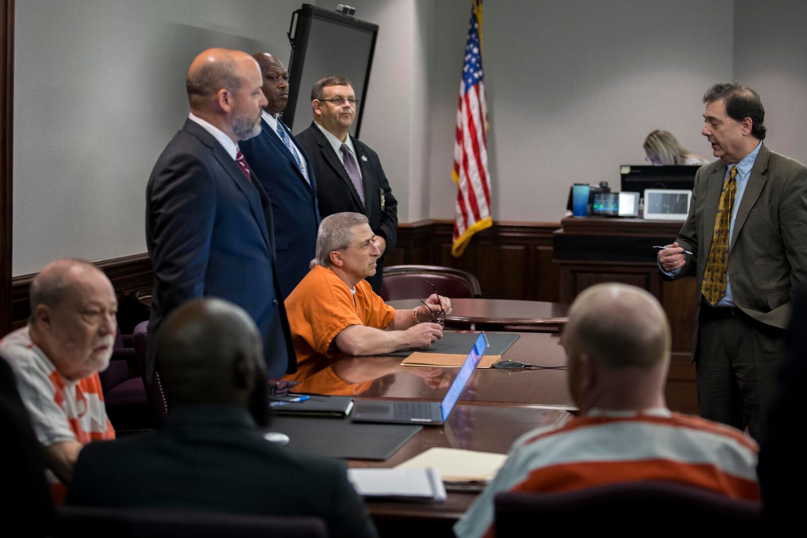 Rodney Zell, left, attorney for William "Roddie" Bryan, seated center, speaks with his client during a break in the hearing for a new trial, Thursday, Oct. 24, 2024, in Brunswick, Ga. (AP Photo/Stephen B. Morton)