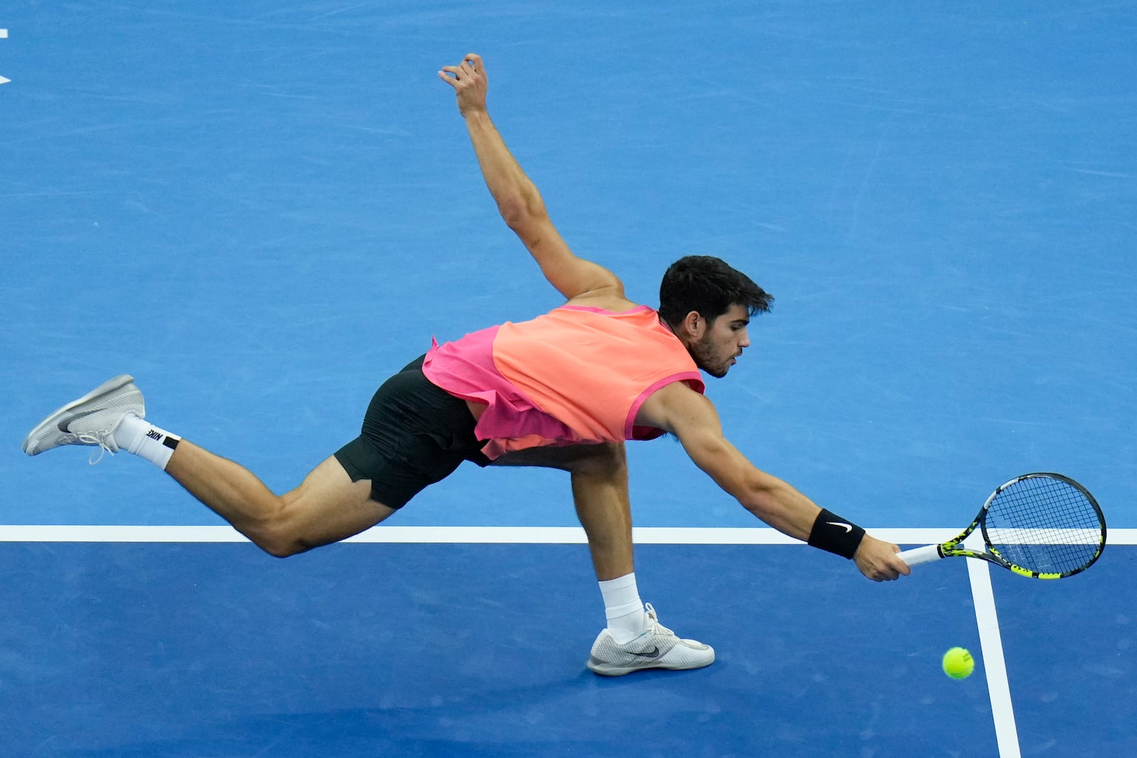 Carlos Alcaraz of Spain chases the ball from Jannik Sinner of Italy during their men's singles finals match of the China Open tennis tournament, at the National Tennis Center in Beijing, Wednesday, Oct. 2, 2024. (AP Photo/Andy Wong)