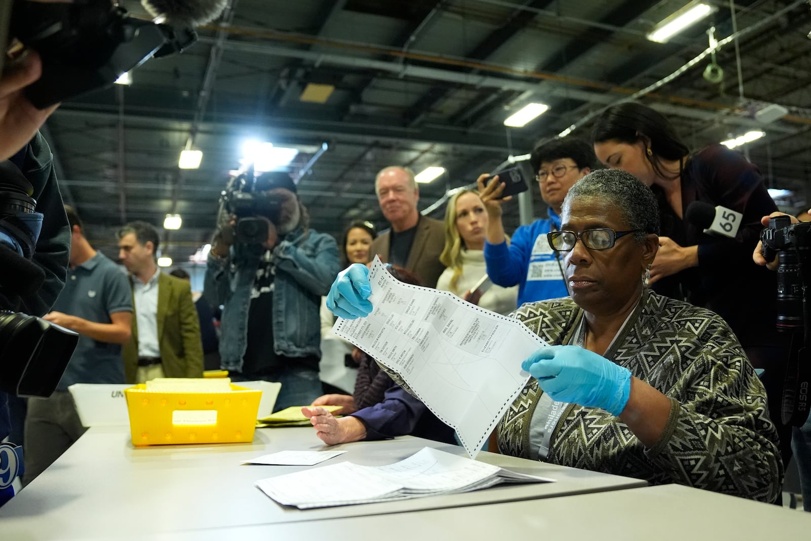 An election worker demonstrates mail-in ballot processing during a media preview at the Philadelphia Election Warehouse, in Philadelphia, Friday, Oct. 25, 2024. (AP Photo/Matt Rourke)