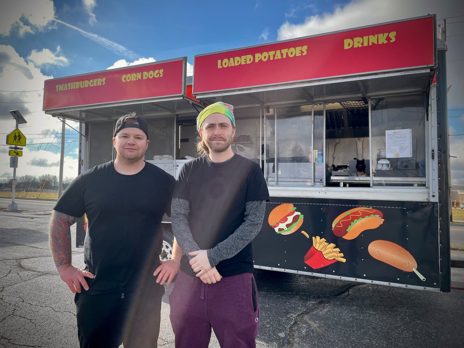 Tasty Bacon’s, a new food truck offering smash burgers, hand dipped corn dogs, loaded potatoes and breakfast items, is now serving the Fairborn area. Pictured (left to right) are Owners John Hansen and Jordan Zimmerman. NATALIE JONES/STAFF