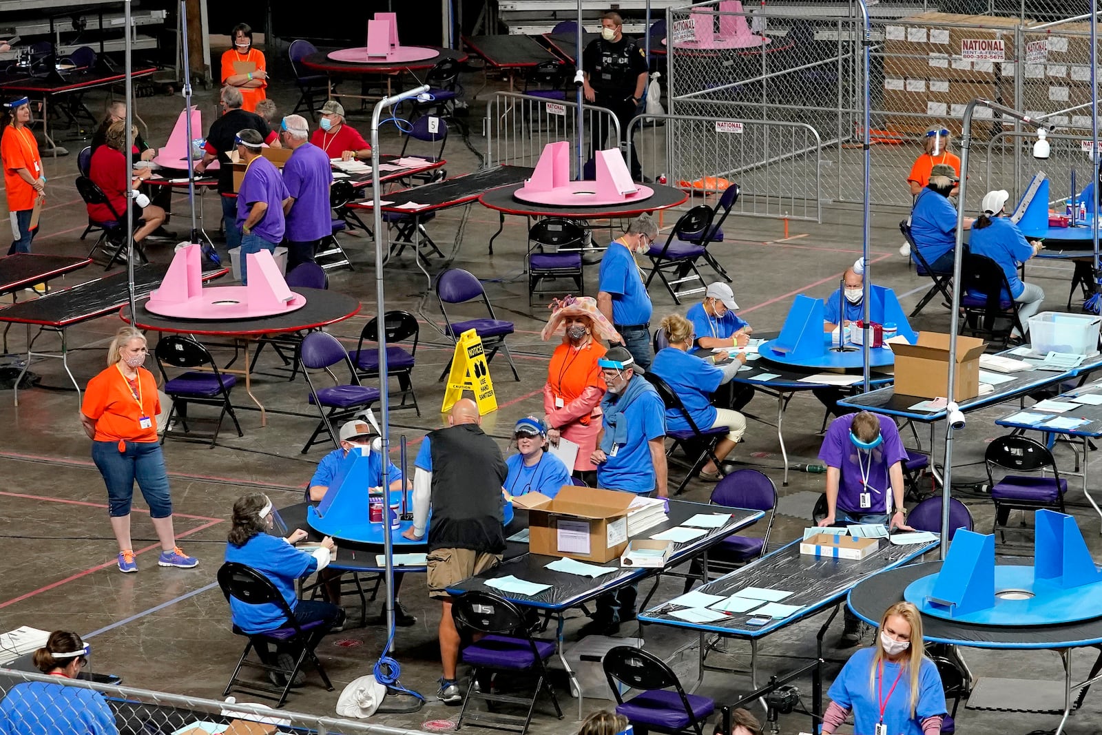 FILE - Maricopa County ballots cast in the 2020 general election are examined and recounted by contractors working for Florida-based company, Cyber Ninjas at Veterans Memorial Coliseum in Phoenix, May 6, 2021. (AP Photo/Matt York, Pool, File)