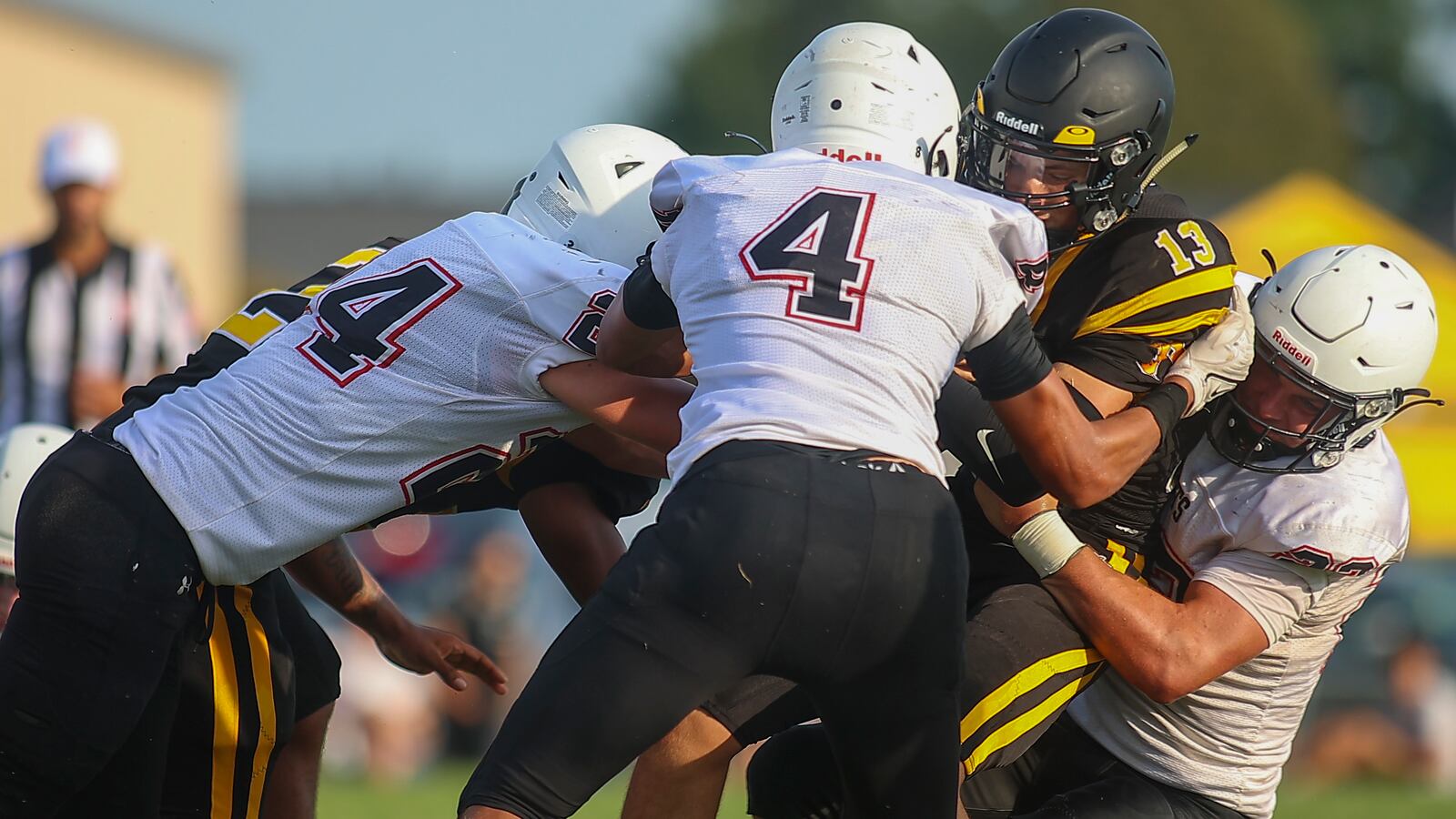 A group of Greenon High School defenders bring down Shawnee's Zane Mercer during their scrimmage game on Friday, Aug. 13 in Springfield. CONTRIBUTED PHOTO BY MICHAEL COOPER