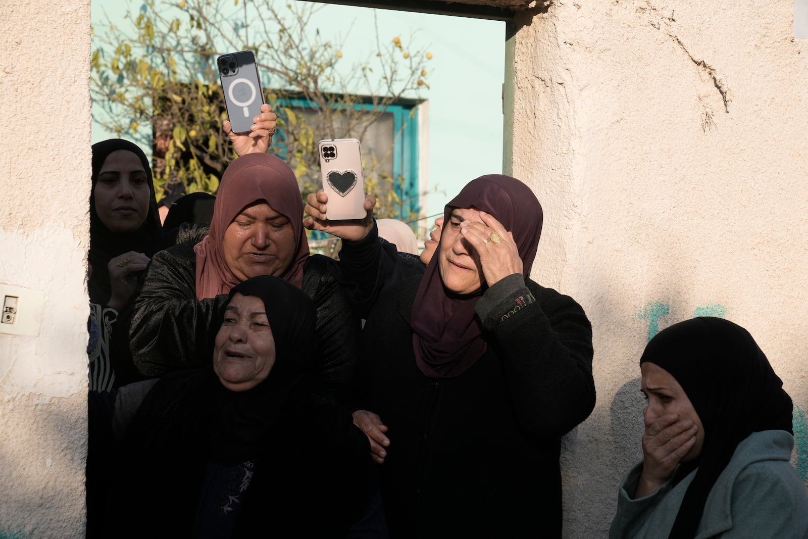 Mourners follow the funeral of Akram Abu Arrah and Mohammad Ghannam, both killed in an airstrike Israel said targeted a militant cell, in the West Bank village of Al-Aqaba, Tuesday Dec. 3, 2024. (AP Photo/Majdi Muhammad)