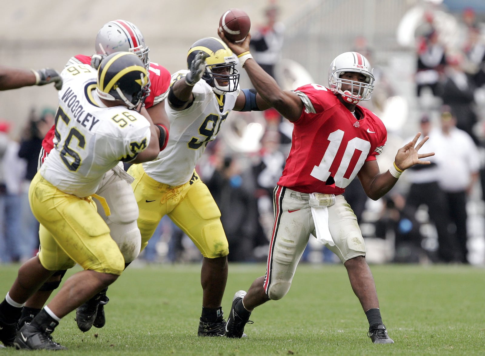 COLUMBUS, OH - NOVEMBER 20:  Quarterback Troy Smith #10 of the Ohio State Buckeyes throws under pressure from defensive end LaMarr Woodley #56 and defensive tackle Marques Walton #95 of the Michigan Wolverines on November 20, 2004 at Ohio Stadium in Columbus, Ohio.  Ohio State upset Michigan 37-21.  (Photo by Brian Bahr/Getty Images)