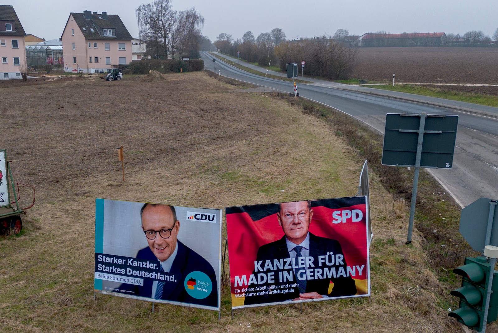 FILE - Election posters, showing German Chancellor Olaf Scholz, right, and CDU top candidate Friedrich Merz, stand on a meadow in Nieder-Erlenbach near Frankfurt, Germany, Feb. 5, 2025. (AP Photo/Michael Probst, File)