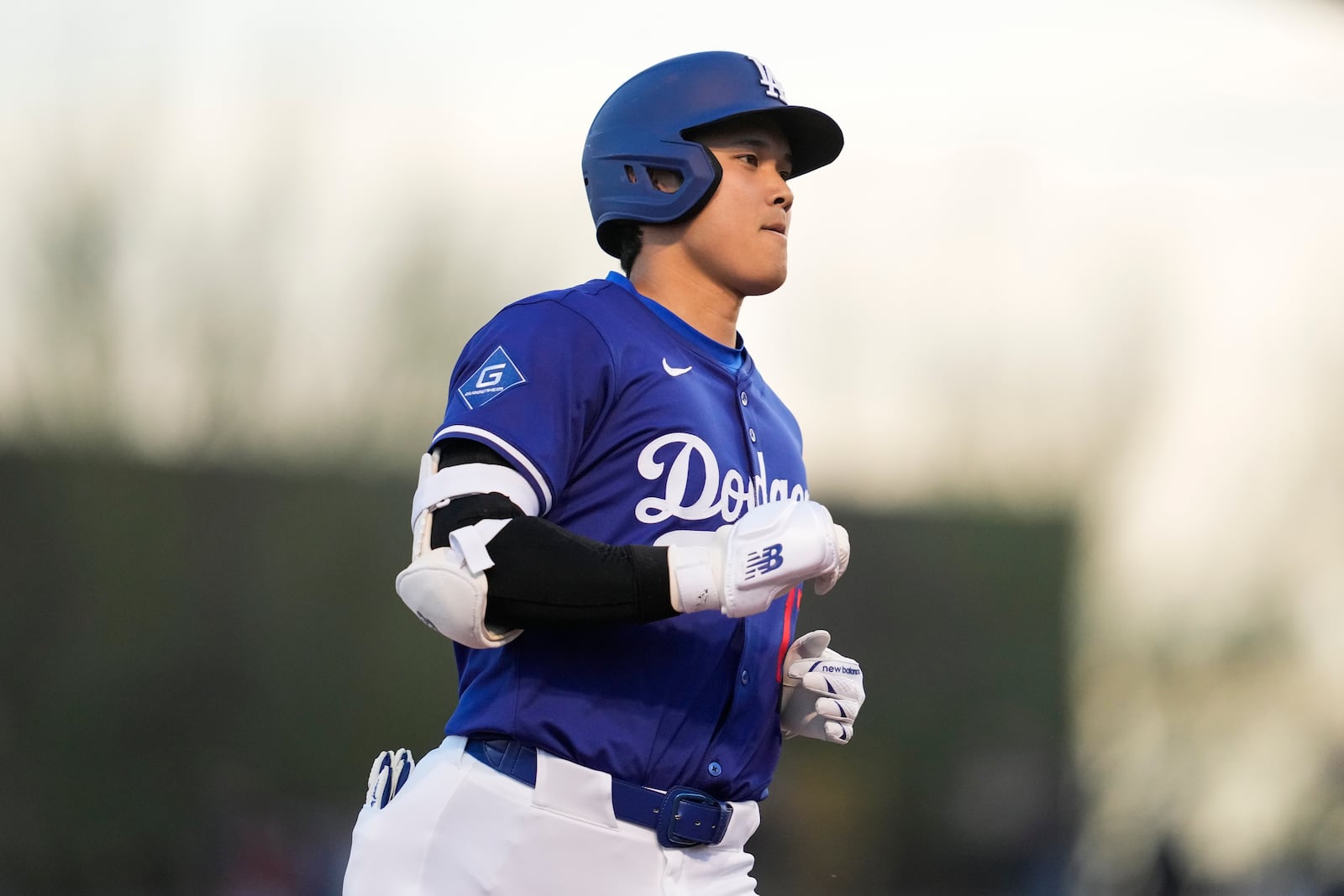 Los Angeles Dodgers designated hitter Shohei Ohtani runs the bases after hitting a home run during the first inning of a spring training baseball game Los Angeles Angels, Friday, Feb. 28, 2025, in Phoenix. (AP Photo/Ashley Landis)