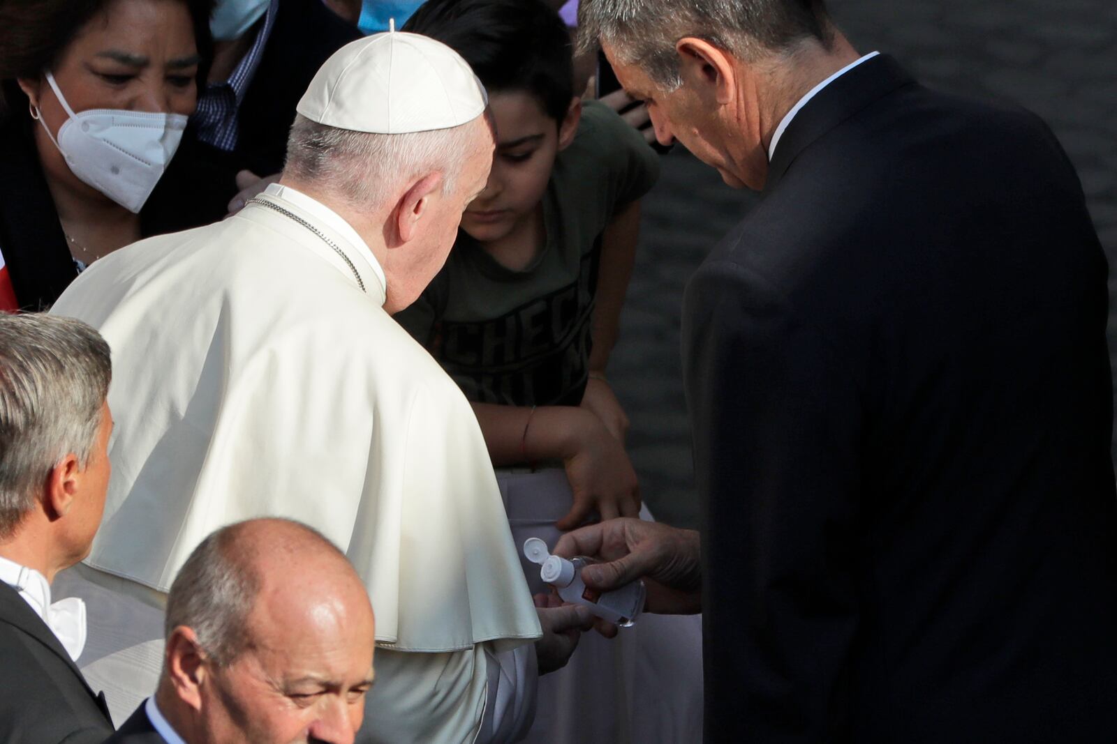 Pope Francis has his hands sanitized by his personal assistant during his weekly general audience in San Damaso courtyard at the Vatican, Wednesday, Sept. 9, 2020. (AP Photo/Andrew Medichini)