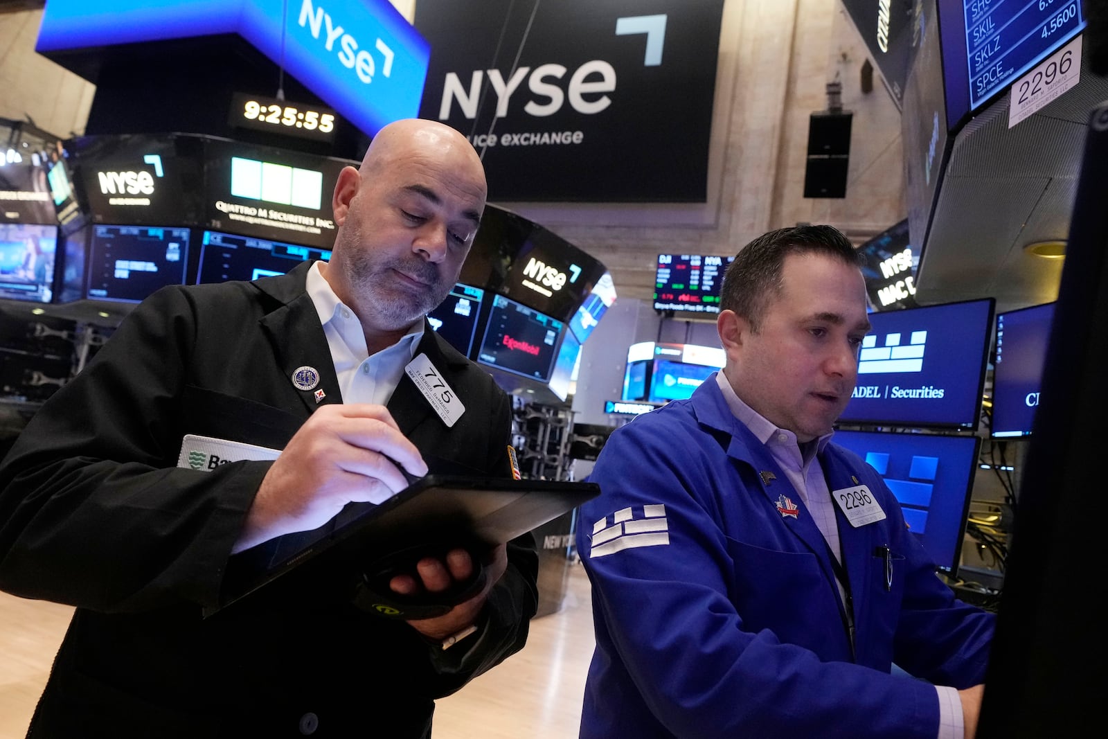 Trader Fred Demarco, left, and specialist Genaro Saporito work the floor of the New York Stock Exchange, Tuesday, Feb. 4, 2025. (AP Photo/Richard Drew)