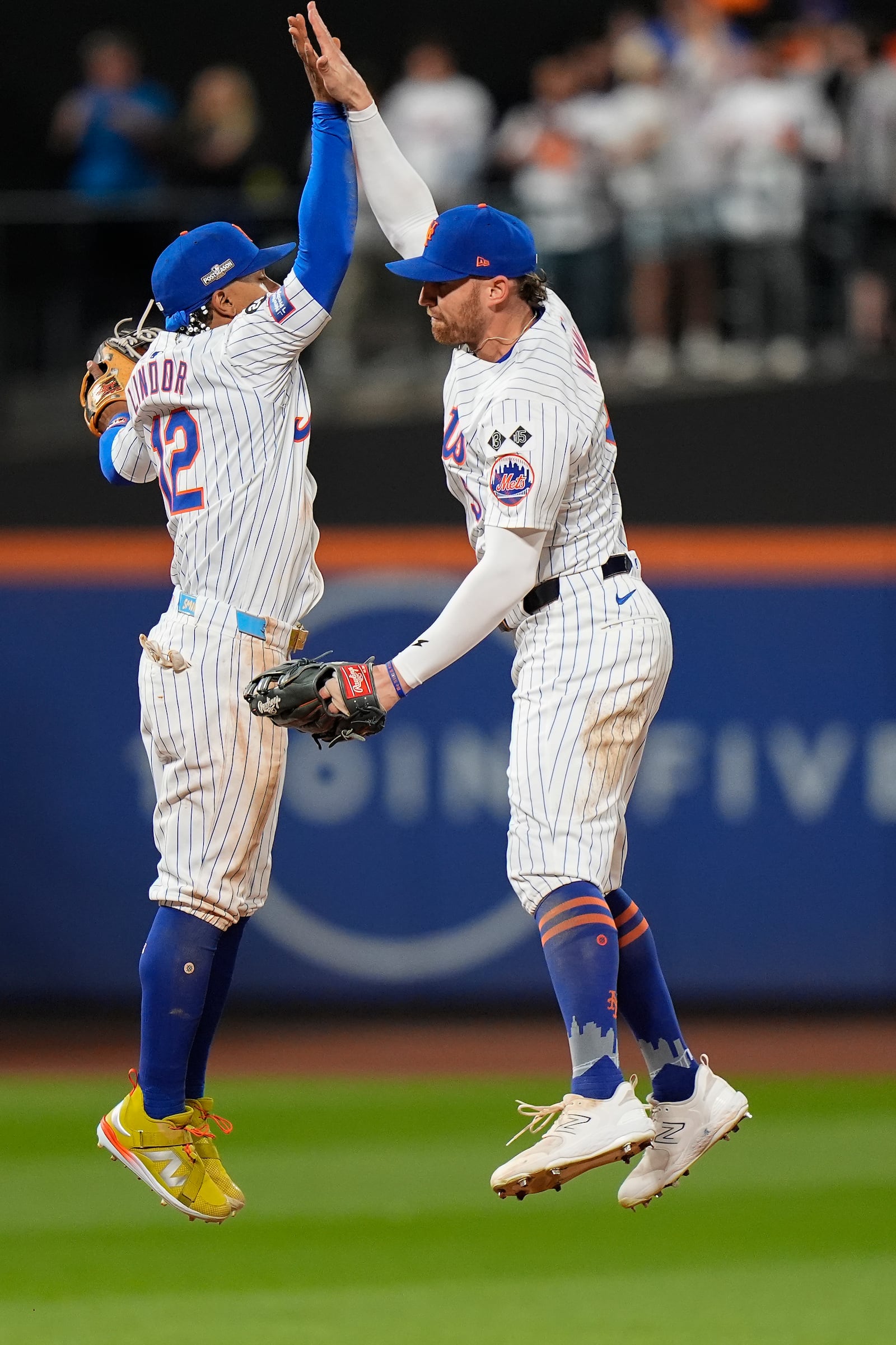 New York Mets shortstop Francisco Lindor (12) and outfielder Brandon Nimmo (9) celebrate after defeating the Philadelphia Phillies in Game 3 of the National League baseball playoff series, Tuesday, Oct. 8, 2024, in New York. (AP Photo/Frank Franklin II)