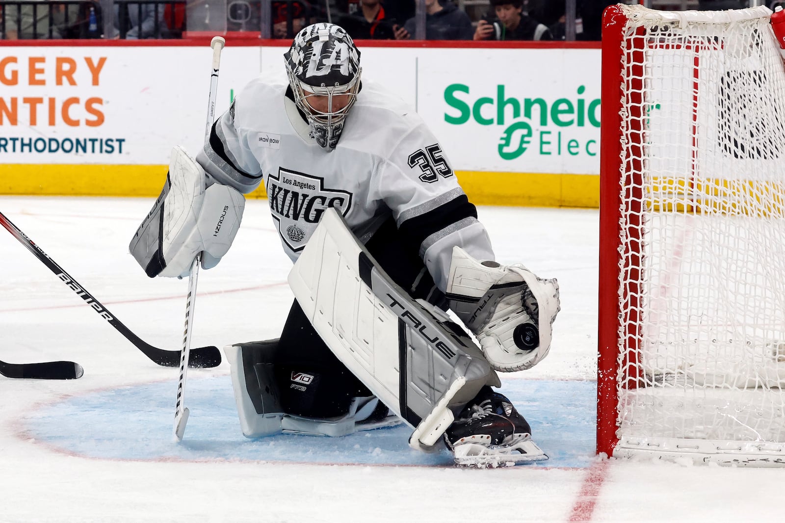 Los Angeles Kings goaltender Darcy Kuemper (35) snares a shot by the Carolina Hurricanes during the second period of an NHL hockey game in Raleigh, N.C., Saturday, Feb. 1, 2025. (AP Photo/Karl DeBlaker)