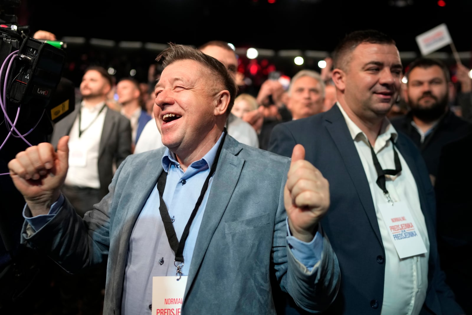 Supporters of President incumbent Zoran Milanovic react to exit polls of a runoff vote for the Croatian presidential election at his election headquarters in Zagreb, Croatia, Sunday, Jan. 12, 2025. (AP Photo/Darko Bandic)